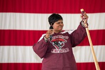 Chief Master Sgt. Felica Noil, 91st Missile Wing command chief, raises her bully stick on stage inside the 91st MW Bully Dome at Minot Air Force Base, N.D., Aug. 6, 2015. Noil spoke to the competitors after the 91st MW Global Strike Challenge teams were introduced at the official kickoff. (U.S. Air Force photo/Airman 1st Class Justin T. Armstrong)