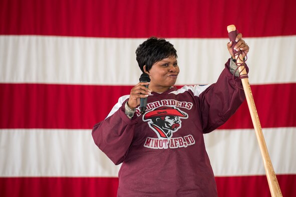 Chief Master Sgt. Felica Noil, 91st Missile Wing command chief, raises her bully stick on stage inside the 91st MW Bully Dome at Minot Air Force Base, N.D., Aug. 6, 2015. Noil spoke to the competitors after the 91st MW Global Strike Challenge teams were introduced at the official kickoff. (U.S. Air Force photo/Airman 1st Class Justin T. Armstrong)