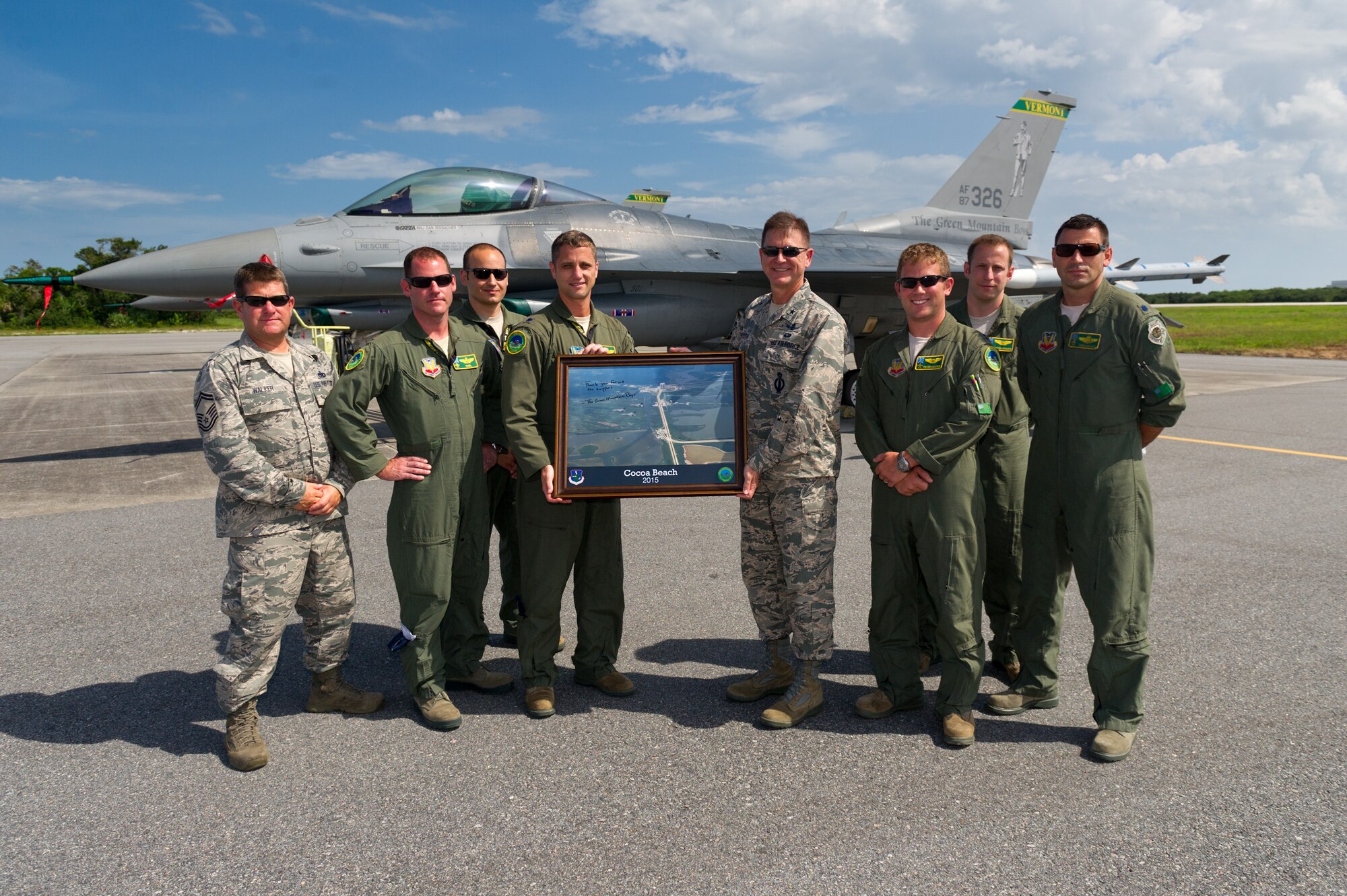 Brig. Gen. Wayne Monteith, 45th Space Wing commander, receives a token of appreciation from members of the Vermont Air National Guard, Aug. 6, 2015, at the Skid Strip at Cape Canaveral Air Force Station, Fla. The Vermont Air National Guard used the airfield at the Cape for a base of operations during their Dissimilar Aircraft Combat Training Exercise in order to train and hone their combat skills. (U.S. Air Force photo by Cory Long/Released) 