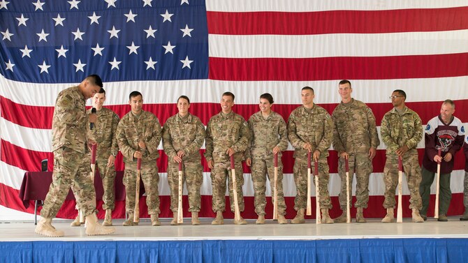 The 791st Missile Security Forces Squadron Global Strike Challenge team is introduced on stage with their bully sticks inside the 91st Missile Wing Bully Dome at Minot Air Force Base, N.D., Aug. 6, 2015. Personalized bully sticks were made for each 91st MW Global Strike Challenge competitor and presented to them during the official kickoff. (U.S. Air Force photo/Airman 1st Class Justin T. Armstrong)