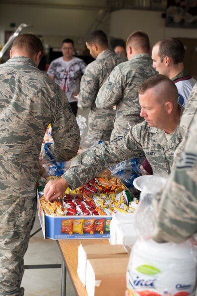 Airmen from the 91st Missile Wing grab lunch during the official Global Strike Challenge kickoff in the 91st MW Bully Dome at Minot Air Force Base, N.D., Aug. 6, 2015. Hamburgers and hotdogs were grilled for attendees at the kickoff. (U.S. Air Force photo/Airman 1st Class Justin T. Armstrong)