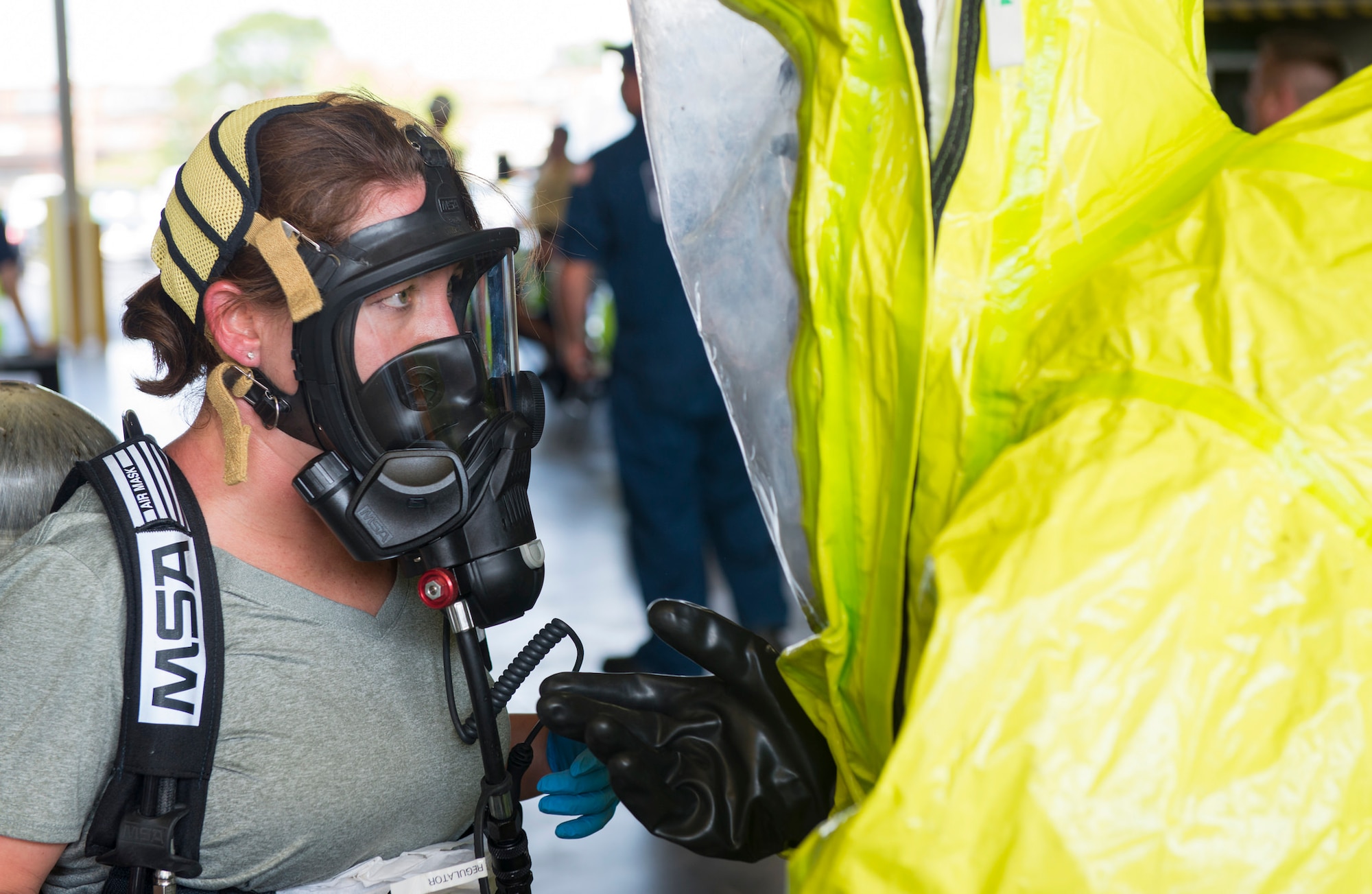 Petty Officer 1st Class Nichelle Flynn, U.S. Coast Guard Atlantic Strike Team store keeper, learns about decontamination procedures during a hazardous materials scenario on Joint Base McGuire-Dix-Lakehurst, N.J., Aug. 6, 2015. The emergency scenario featured a hazardous material spill and AST needed to determine contents, mitigate the leak and recommend disposal options. (U.S. Air Force photo by Airman 1st Class Joshua King/Released)