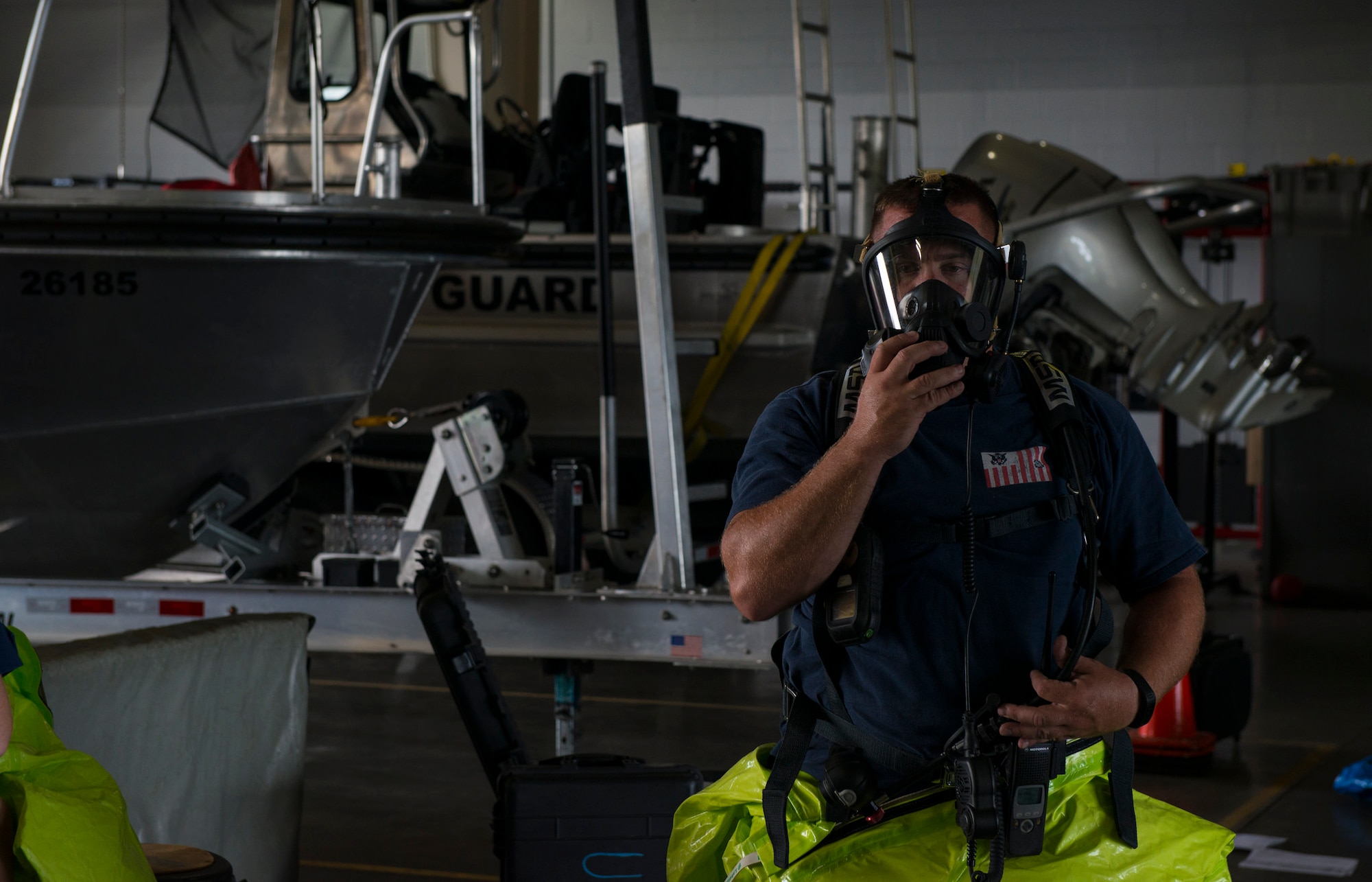 Petty Officer 1st Class Rich Forte, U.S. Coast Guard Atlantic Strike Team marine science technician, demonstrates decontamination procedures during a hazardous materials scenario on Joint Base McGuire-Dix-Lakehurst, N.J., Aug. 6, 2015. The emergency scenario featured a hazardous material spill and AST needed to determine contents, mitigate the leak and recommend disposal options. (U.S. Air Force photo by Airman 1st Class Joshua King/Released)