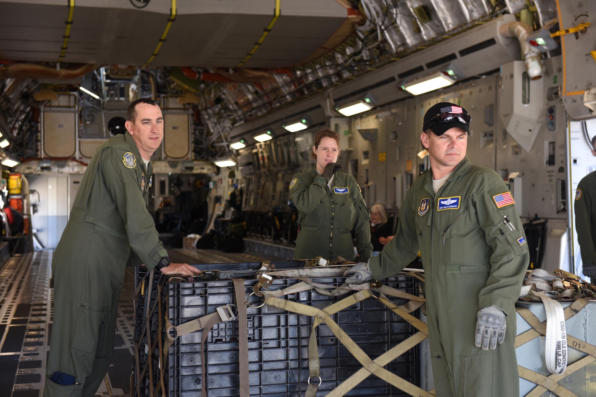 (From left) Tech. Sgt. Justin Brothers, Master Sgt. Caroline Sussman, and Master Sgt. Kelly Earehart wait to offload cargo onto a forklift during joint multi-unit C-17 Globemaster III deployment training exercises June 6, 2016 at the 180th Fighter Wing in Swanton, Ohio. The exercises provided training on the proper handling and placement capabilities of deployable assets to Airmen of all ranks.  (Air National Guard photo by SSgt Shane Hughes/Released)