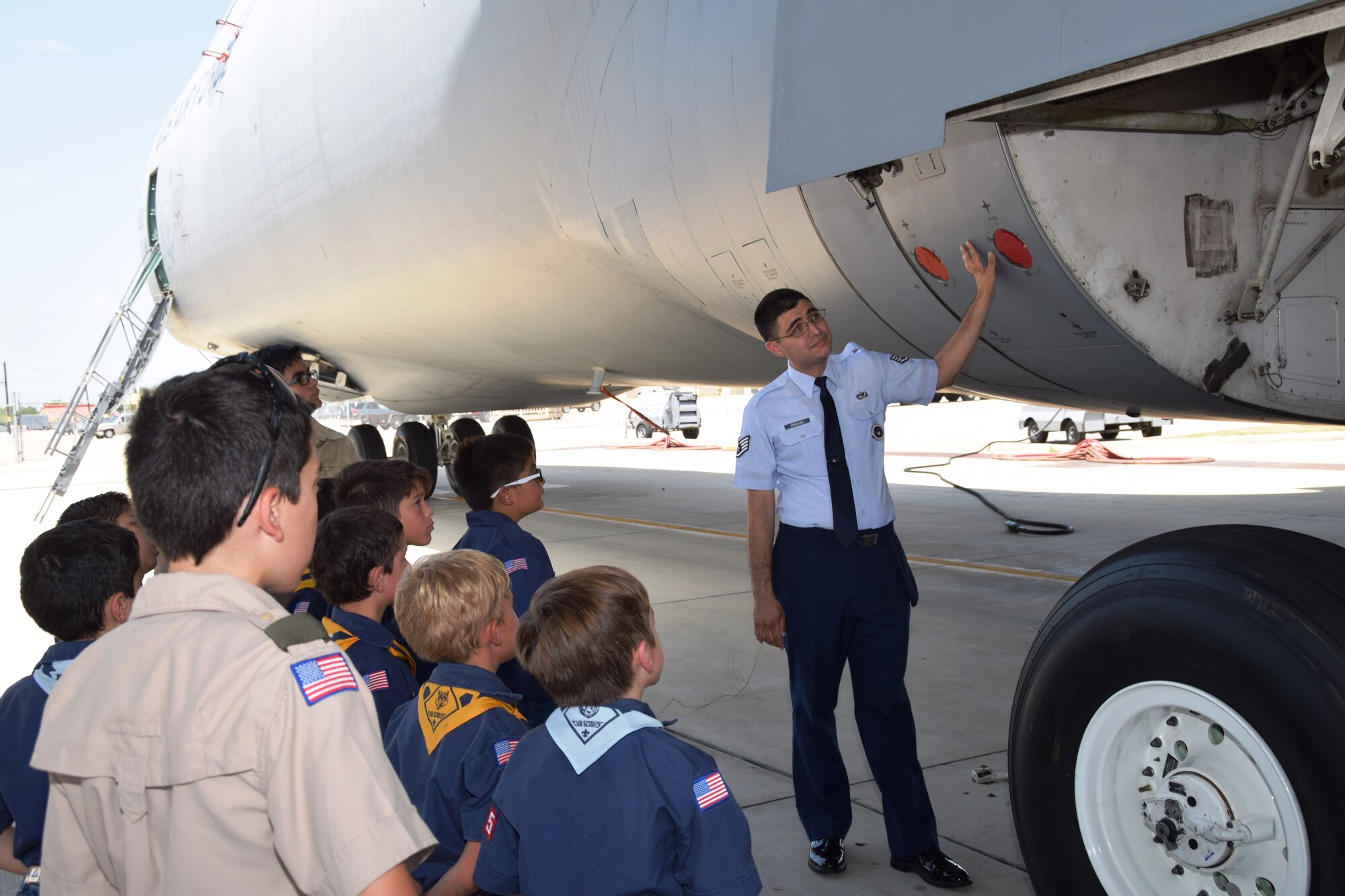 Staff Sgt. Raymond Gonzalez, an aircraft maintenance instructor from the Inter American Air Force Academy at Joint Base San Antonio-Lackland, Texas, explains to the Scouts from Troop 375 about the many parts of landing gear in a C-5A Galaxy on August 6.  Gonzalez taught the Scouts about the cost of each tire, and the pneumatic shocks on the C-5A.  (U.S. Air Force photo/Tech. Sgt. Carlos J. Treviño)