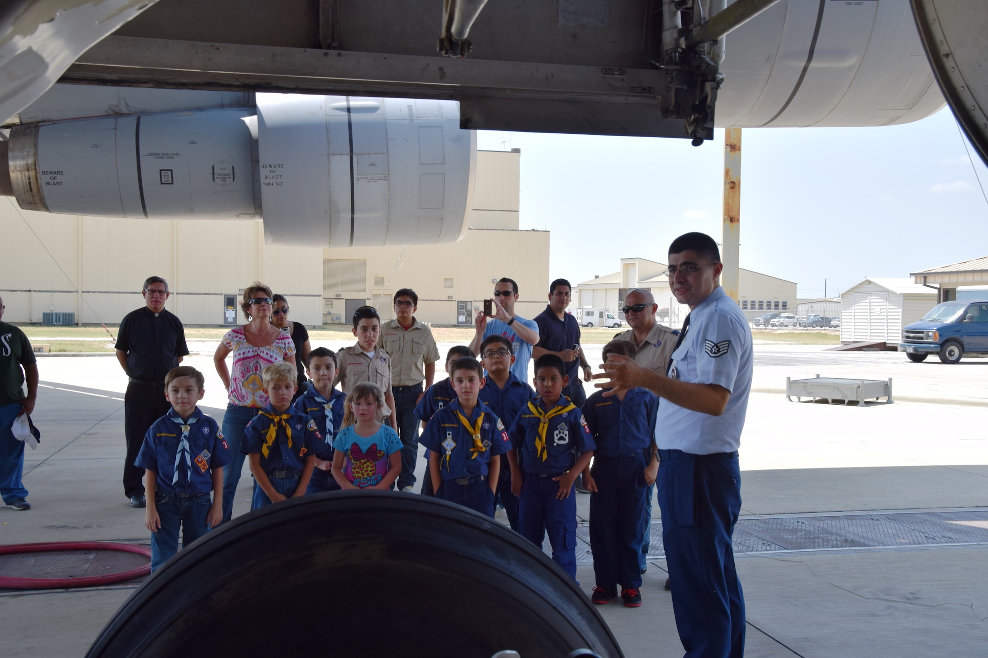 Staff Sgt. Raymond Gonzalez, an aircraft maintenance instructor from the Inter-American Air Force Academy, Joint Base San Antonio-Lackland, Texas, explains to the Scouts from Troop 375 about the many parts of landing gear in a C-5A Galaxy on Aug. 6, 2015. Gonzalez taught the Scouts about the cost of each tire, and the pneumatic shocks on the C-5A.  (U.S. Air Force photo/Tech. Sgt. Carlos J. Trevino)