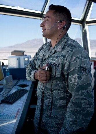 Airman 1st Class Cameron Cabrera, 57th Operations Support Squadron air traffic controller, talks to the pilot of a transient aircraft in the control tower on Nellis Air Force Base, Nev., Aug. 4, 2015. ATC Airmen direct aircraft on the ground and through controlled airspace, and can provide advisory services to aircraft in non-controlled airspace. (U.S. Air Force photo by Airman 1st Class Jake Carter)

