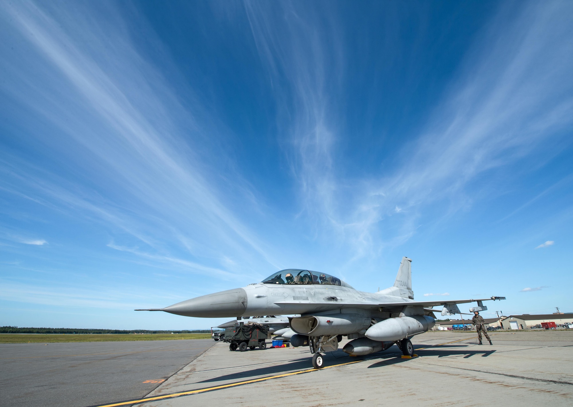A Republic of Korea Air Force (ROKAF) crew chief stands behind an F-16D Fighting Falcon prior to launching the jet Aug. 4, 2015, at Eielson Air Force Base, Alaska. The ROKAF is participating in RED FLAG-Alaska 15-3, a Pacific Air Forces commander-directed field training exercise for U.S. and partner nation forces, providing combined offensive counter-air, interdiction, close air support and large force employment training in a simulated combat environment. (U.S. Air Force photo by Staff Sgt. Shawn Nickel/Released)