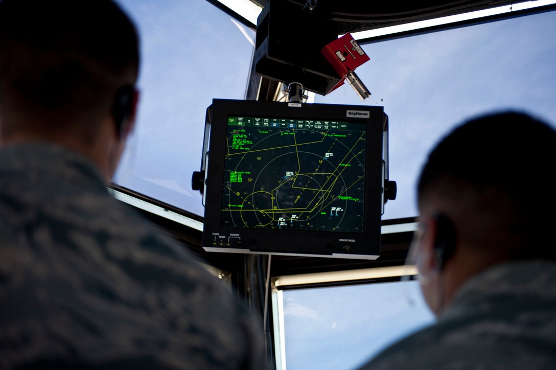 Airmen 1st Class Jacob Garcia and Cameron Cabrera, both 57th Operations Support Squadron air traffic controllers, look at a radar screen in the control tower on Nellis Air Force Base, Nev., Aug. 4, 2015. ATC Airmen monitor radars to ensure proper separation rules are applied to air traffic to keep all aircraft at a safe distance from one another. (U.S. Air Force photo by Airman 1st Class Jake Carter)