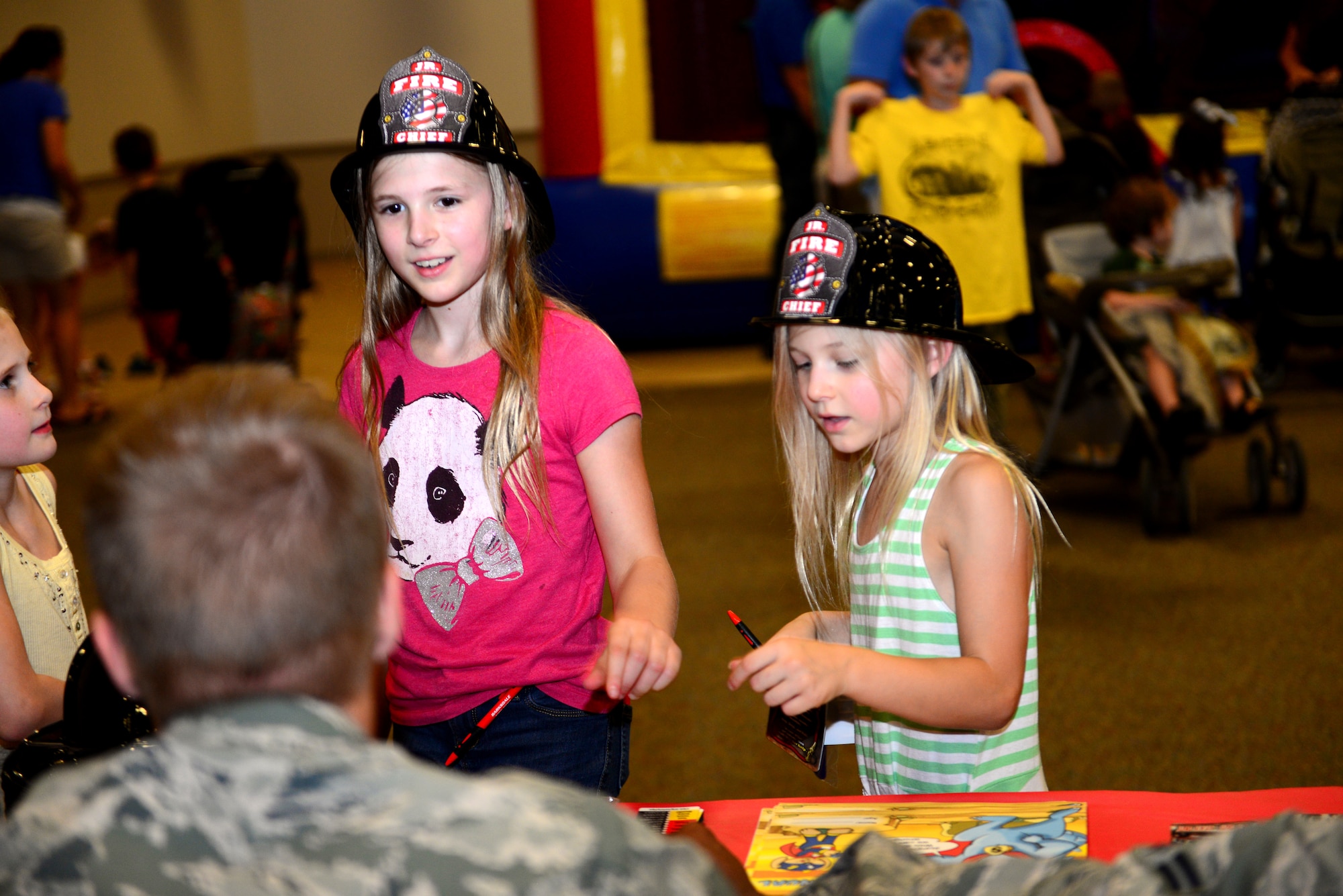 Children learn about the Barksdale’s fire protection program during National Night Out at Barksdale Air Force Base, La., Aug. 4, 2015. Fire protection, explosive ordnance disposal and security force Airmen gave kids a chance to learn some of the exciting things they do while educating them on community programs. (U.S. Air Force photo/Airman 1st Class Luke Hill)