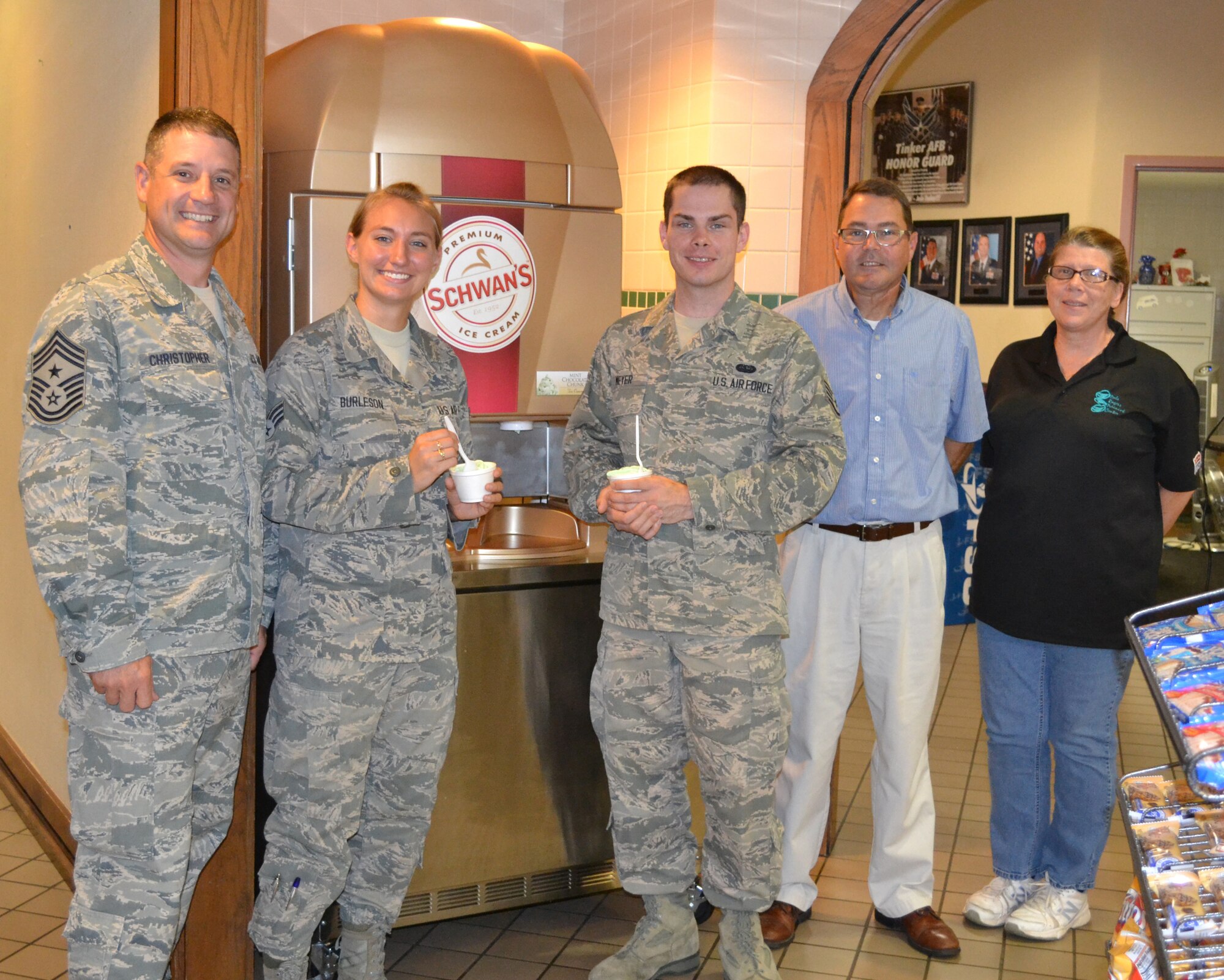 Airmen have a new way to cool off at the Vanwey Dining Facility thanks to a suggestion made by Staff Sgt. James Meyer at a dorm council meeting about a year ago. “We do act on good ideas,” said 72nd Air Base Wing Command Chief Thomas Christopher.  “It may take a while, but we do listen.” Sergeant Meyer, a computer systems programmer with the 552nd Air Network Control Squadron, said he likes the new machine and he’s glad he listened to the technical sergeant who told him to speak up and ask for ice cream during the meeting. The machine currently features chocolate, vanilla, strawberry and chocolate chip mint ice cream, said Nancy Killmeyer, DFAC facility manager. Ms. Killmeyer said she’s also taking requests to see what other flavors people are interested in. They also plan to add cones soon.  Enjoying some ice cream are, from left, Chief Christopher; Senior Airman Noelle Burleson, Dorm Council vice president;  Sergeant Meyer; John Noble, 72nd Force Support Squadron Sustainment Services flight chief; and Ms. Killmeyer.  (Air Force photo by Staff Sgt. Tracy Morrill/Released)