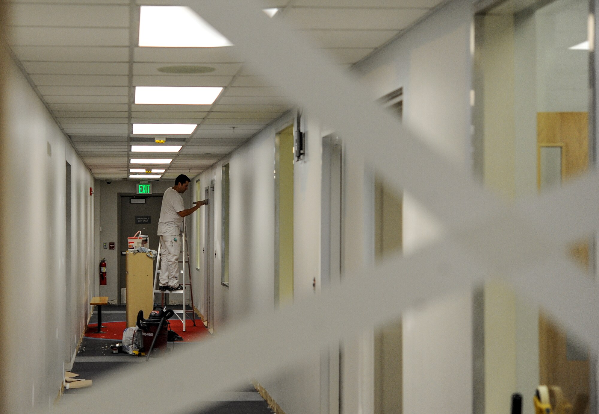 A contractor paints a hallway wall in the McAdoo Sports and Fitness Center at Minot Air Force Base, N.D., July 30, 2015. Renovations in the facility began June 15 , 2015 and are slated for completion September 2015. (U.S. Air Force photo/Senior Airman Stephanie Morris)