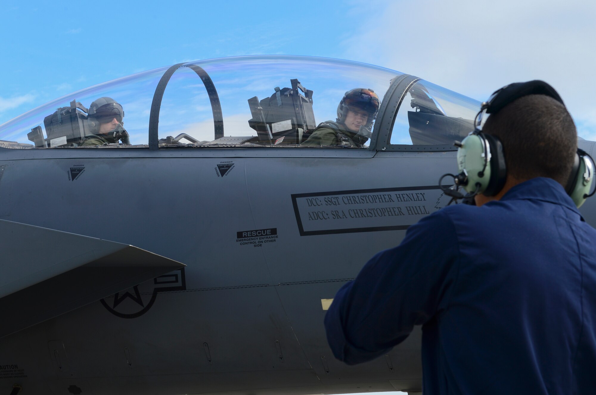 Staff Sgt. Justin Hernandez, 48th Aircraft Maintenance Squadron tactical aircraft maintenance crew chief radios pilots assigned to the 492nd Fighter Squadron while conducting a refueling mission at Royal Air Force Lakenheath, England, Aug. 5, 2015. Hot-pit refueling are conducted while engines are still running, refueling one tank at a time. These types of refueling allow aircraft to return to flight faster.  (U.S. Air Force photo by Senior Airman Dawn M. Weber/Released)