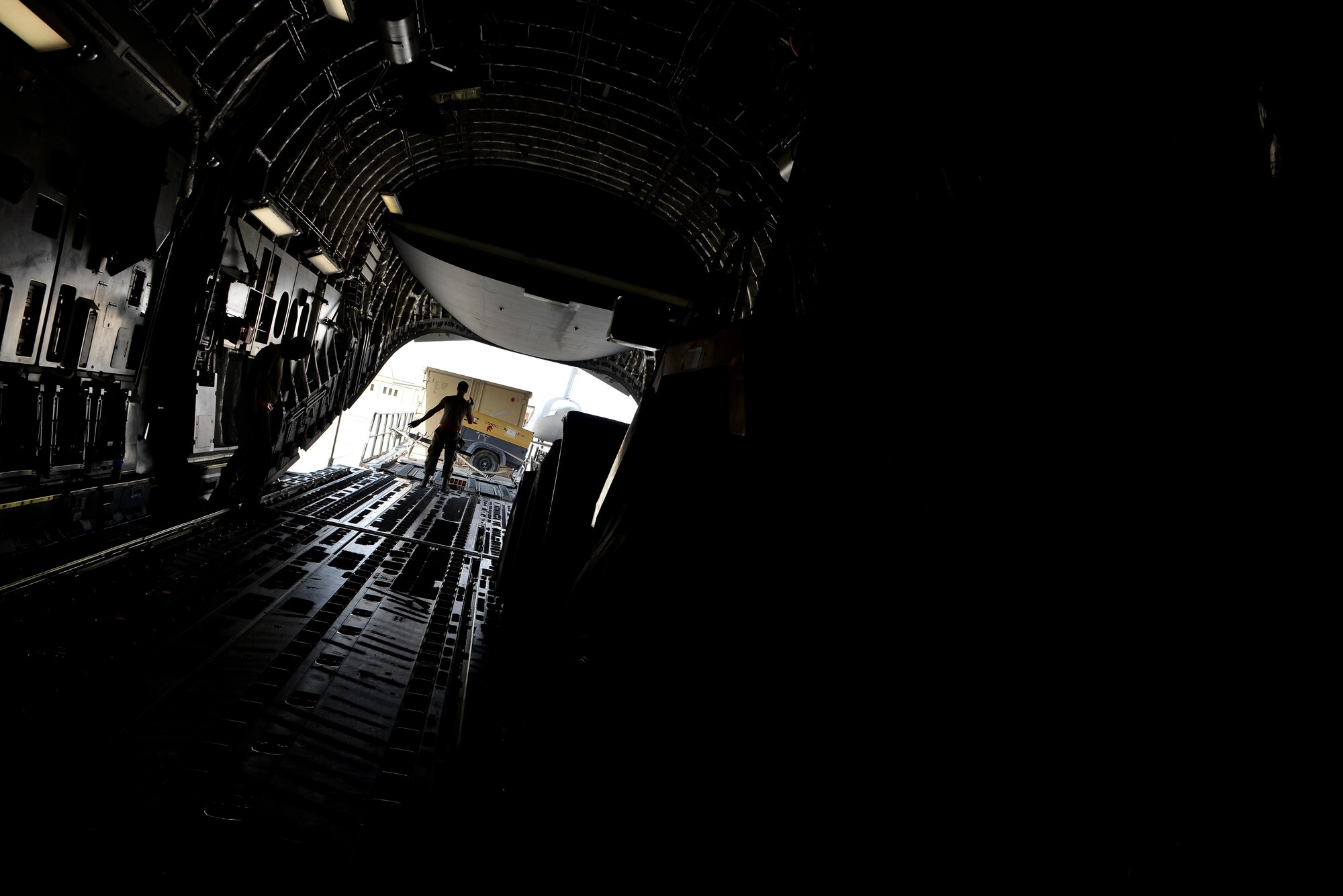 Airmen from the 8th Expeditionary Air Mobility Squadron load generators onto a C-17 Globemaster aircraft prior to take off May 13, 2015 at Al Udeid Air Base, Qatar. Airmen from separate squadrons deployed to Al Udeid helped support a mission for forward deployed members of RED HORSE Civil Engineering to repair a runway in Southwest Asia in support of Operation Inherent Resolve. (U.S. Air Force photo/Staff Sgt. Alexandre Montes) 