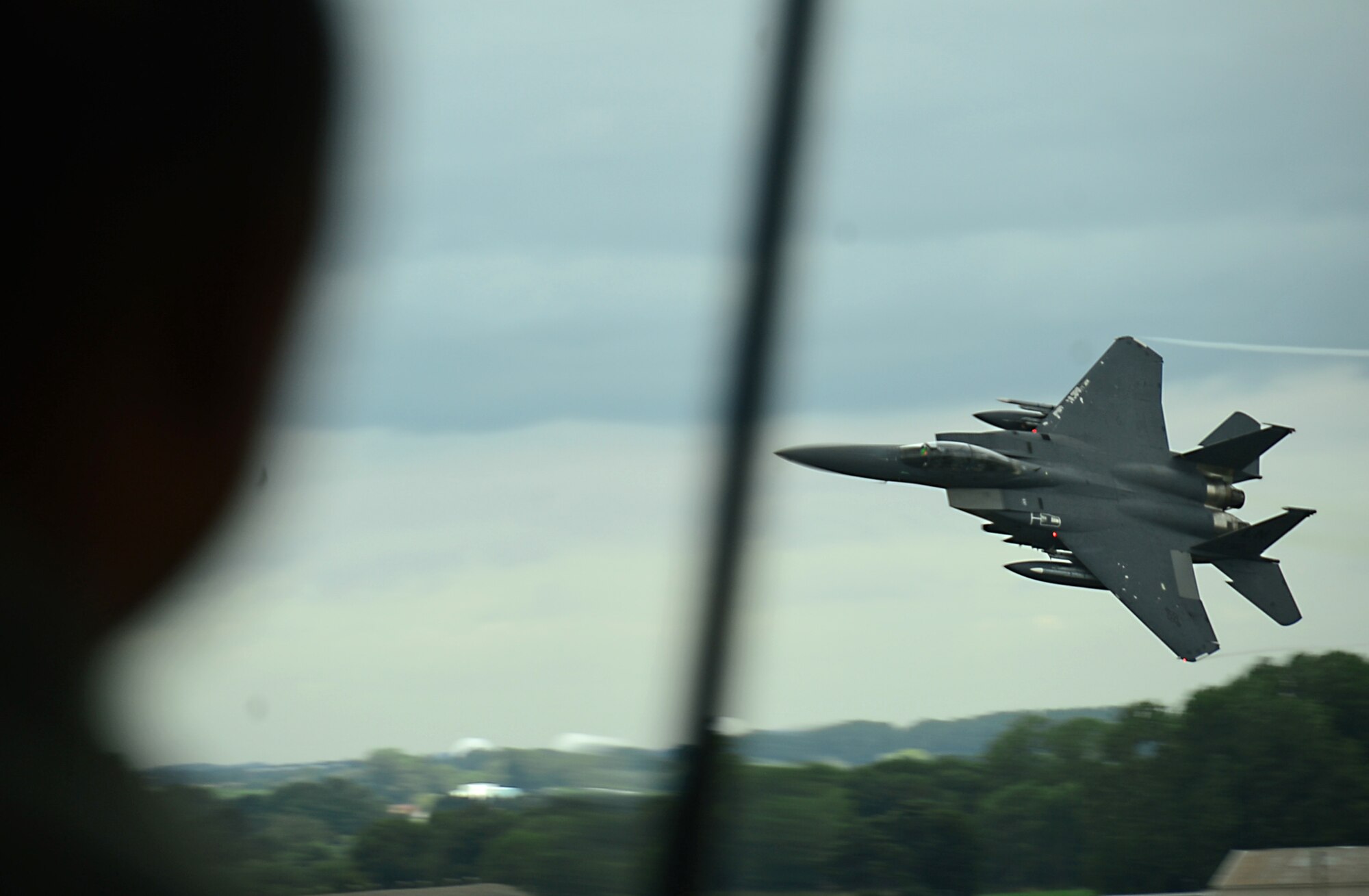 An F-15E Strike Eagle soars past the control tower at Royal Air Force Lakenheath, England, Aug. 6, 2015. The F-15E is a dual-role fighter designed to perform air-to-air and air-to-ground missions, and has the capability to fly at low altitudes day and night in various weather conditions. (U.S. Air Force photo by Senior Airman Erin O’Shea/Released)