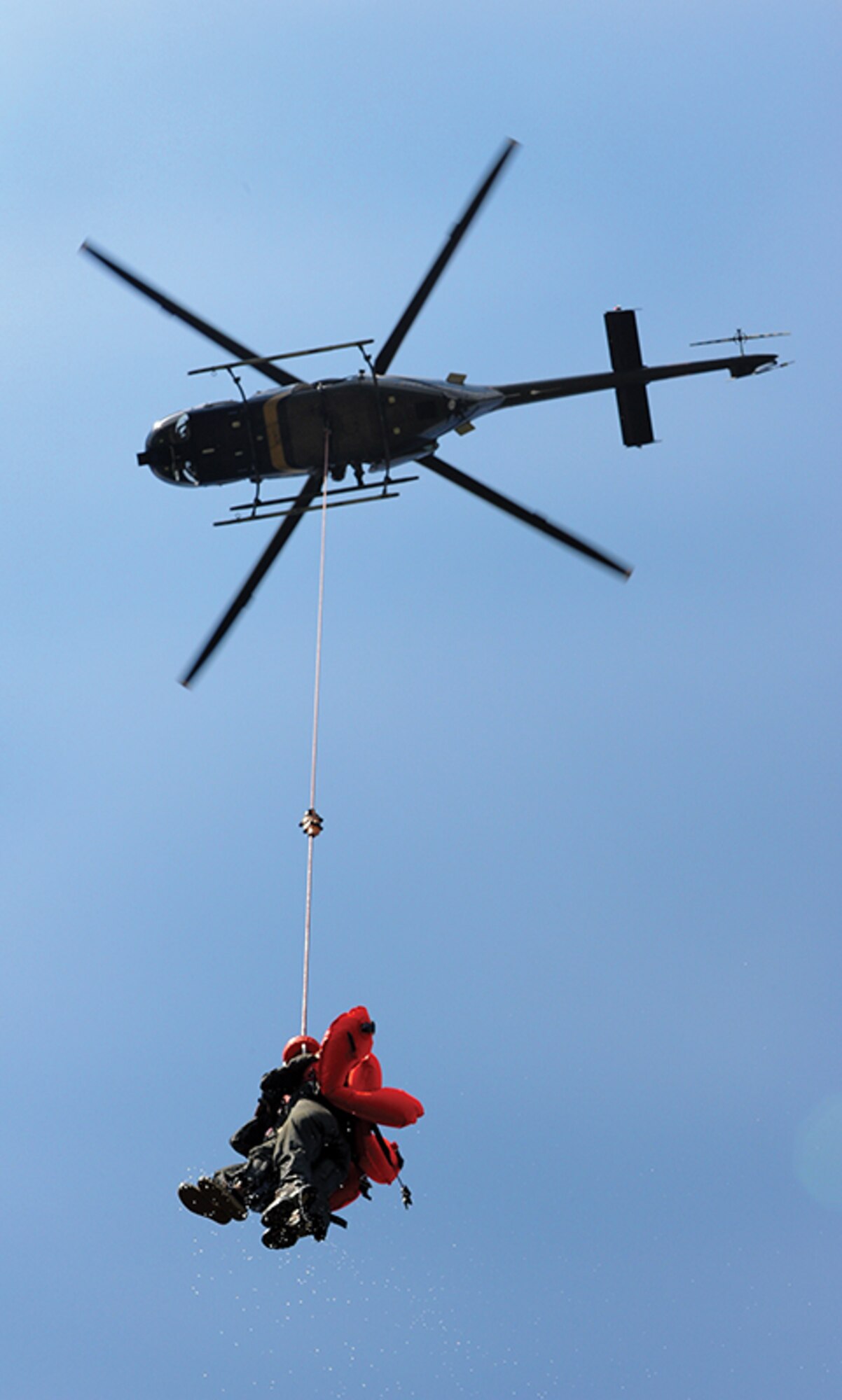 Aircrew members are extracted from the Alabama River by an Alabama Department of Public Safety helicopter. Personnel of the City of Montgomery Police and Fire Departments also provided support for the survival training.