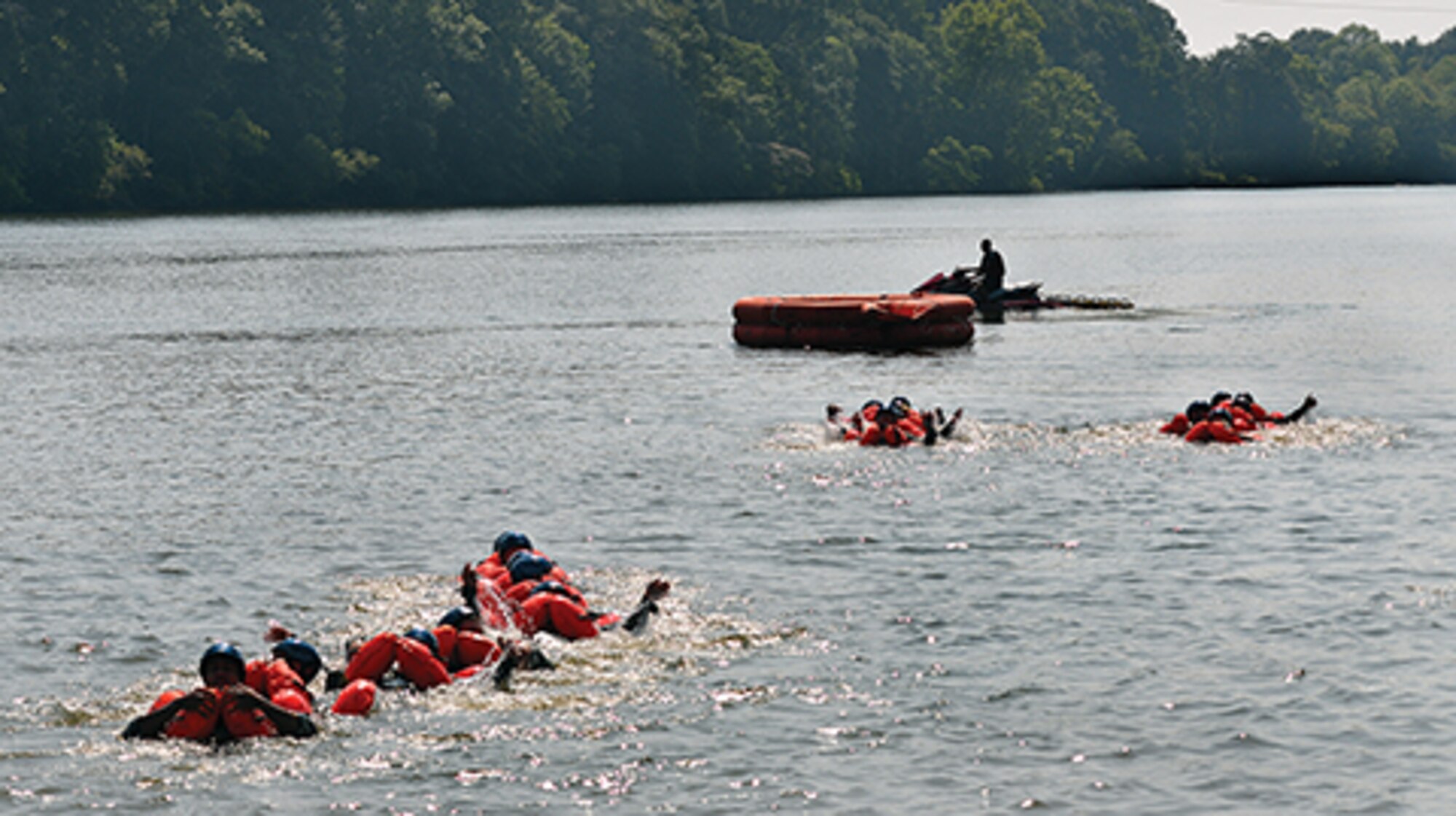 Aircrew members of the 908th Airlift Wing make their way to a 20-man raft during recent water survival training.