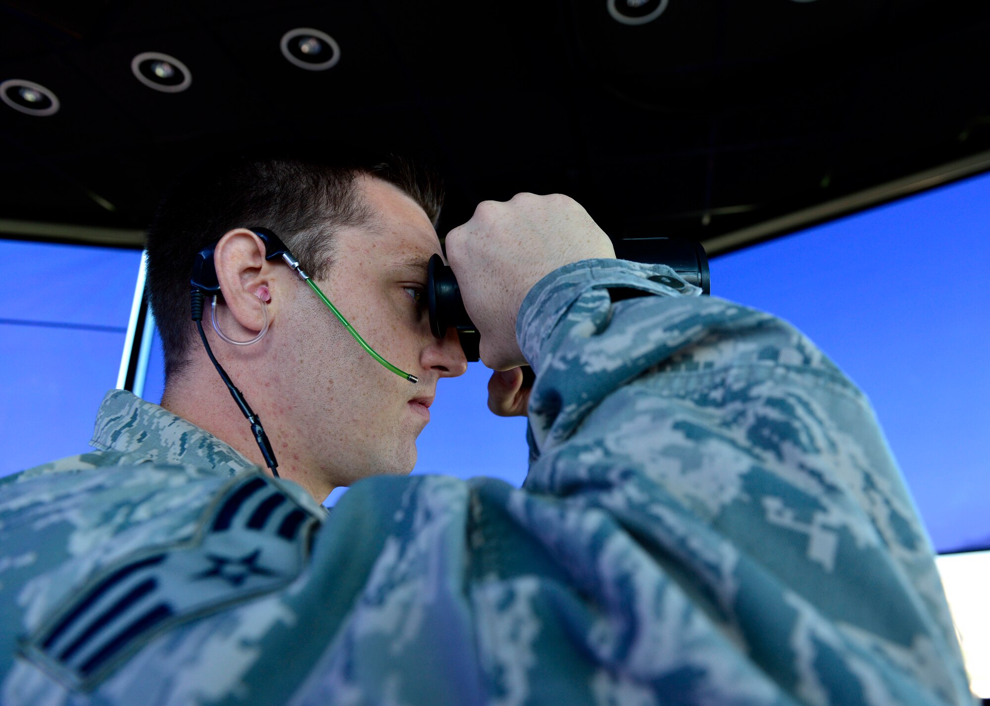 U.S. Air Force Senior Airman Brett Biffle, 31st Operation Support Squadron air traffic controller journeyman, certifies the runway is clear before an aircraft lands, Aug. 5, 2015, at Aviano Air Base, Italy. The tower provides the best view for air traffic controllers to ensure aircraft arrive and depart safely. (U.S. Air Force photo by Airman 1st Class Cary Smith/Released) 
