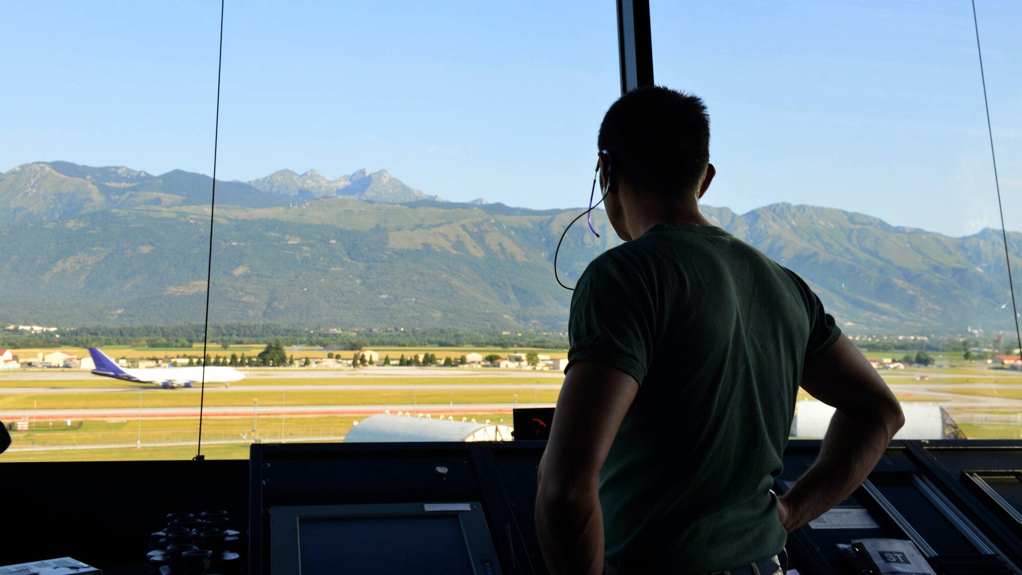 An Italian air force air traffic controller watches an aircraft taxi down the runway, Aug. 5, 2015, at Aviano Air Base, Italy. The tower provides the best view for air traffic controllers to ensure aircraft arrive and depart safely. (U.S. Air Force photo by Airman 1st Class Cary Smith/Released)