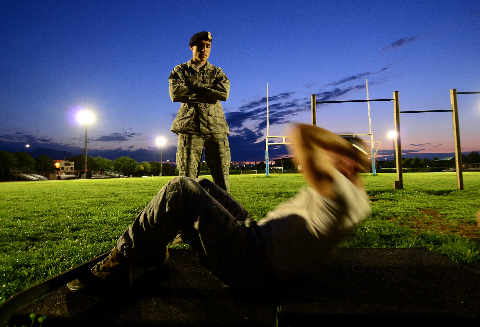 U.S. Air Force Tech. Sgt. Shawn Cecere, 31st Security Forces Squadron training instructor, watches an Airman perform pushups during an Army pre-Ranger physical assessment, Aug. 5, 2015 at Aviano Air Base, Italy.  Several Aviano Airmen participated in the Pre-Ranger course which included a 5-mile run, pushups, situps and chinups. (U.S. Air Force photo by Staff Sgt. Evelyn Chavez/Released)
