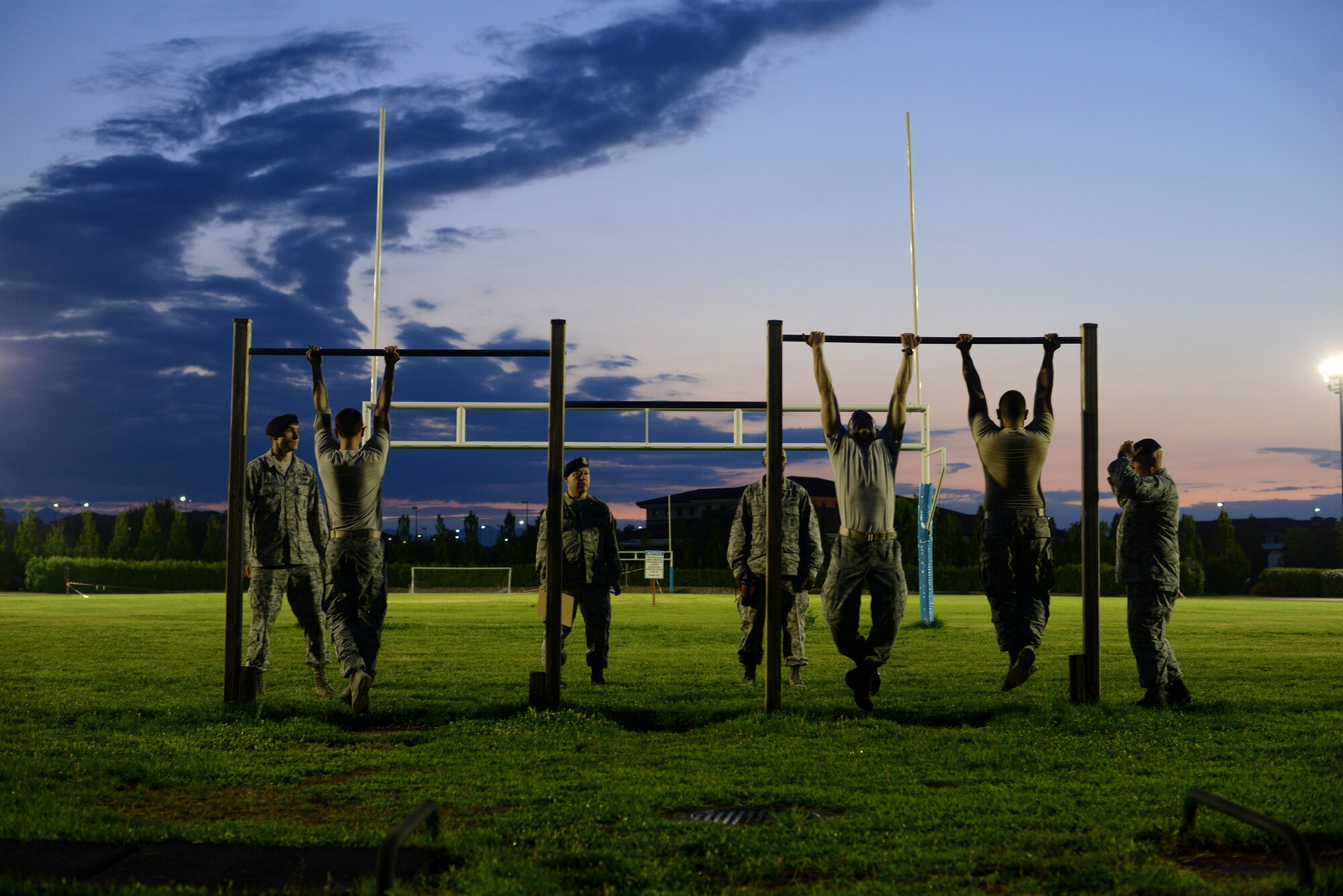 U.S. Air Force Airmen prepare for chin ups during an Army pre-Ranger physical assessment, Aug. 5, 2015 at Aviano Air Base, Italy.  The assessment included a 5-mile run, pushups, situps and chinups. (U.S. Air Force photo by Staff Sgt. Evelyn Chavez/Released)