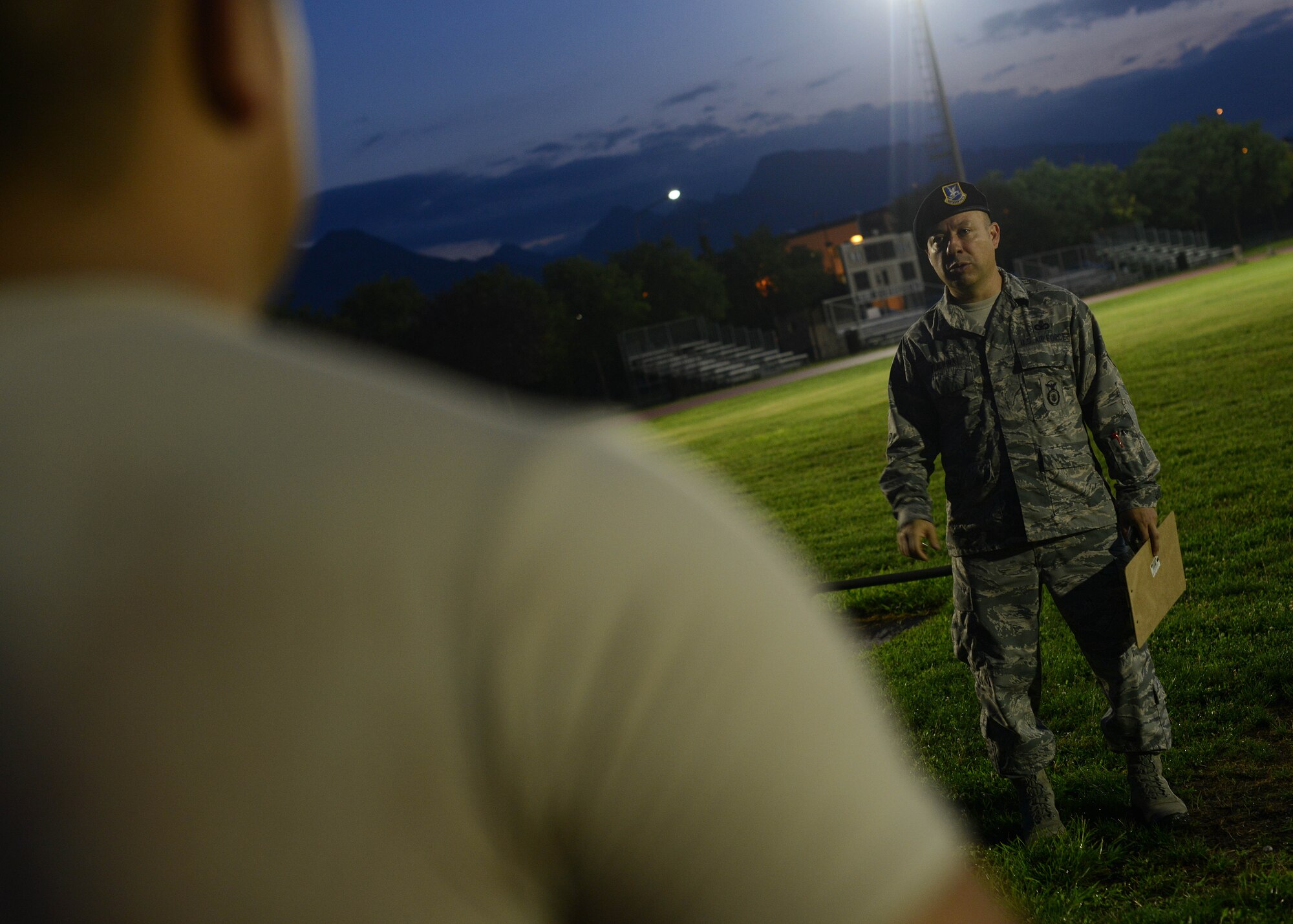 U.S. Air Force Senior Master Sgt. Steven Tijerina, 31st Security Forces Squadron superintendent, instructs Airmen on proper pushup form during an Army pre-Ranger physical assessment, Aug. 5, 2015 at Aviano Air Base, Italy. Rios and several Aviano Airmen participated in the pre-Ranger course which included a 5-mile run, pushups, situps and chinups. (U.S. Air Force photo by Staff Sgt. Evelyn Chavez/Released)