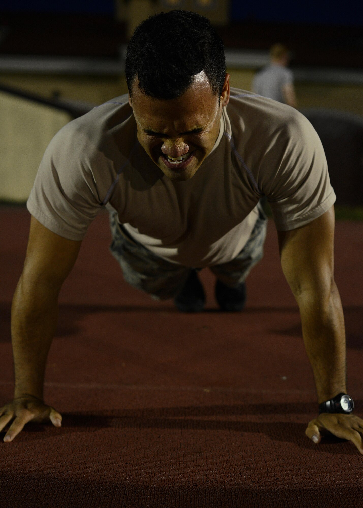 U.S. Air Force Airman 1st Class Ricardo Rios, 31st Security Forces Squadron defender performs a push up during an Army pre-Ranger physical assessment, Aug. 5, 2015 at Aviano Air Base, Italy. Rios and several Aviano Airmen participated in the pre-Ranger course which included a 5-mile run, pushups, situps and chinups. (U.S. Air Force photo by Staff Sgt. Evelyn Chavez/Released)