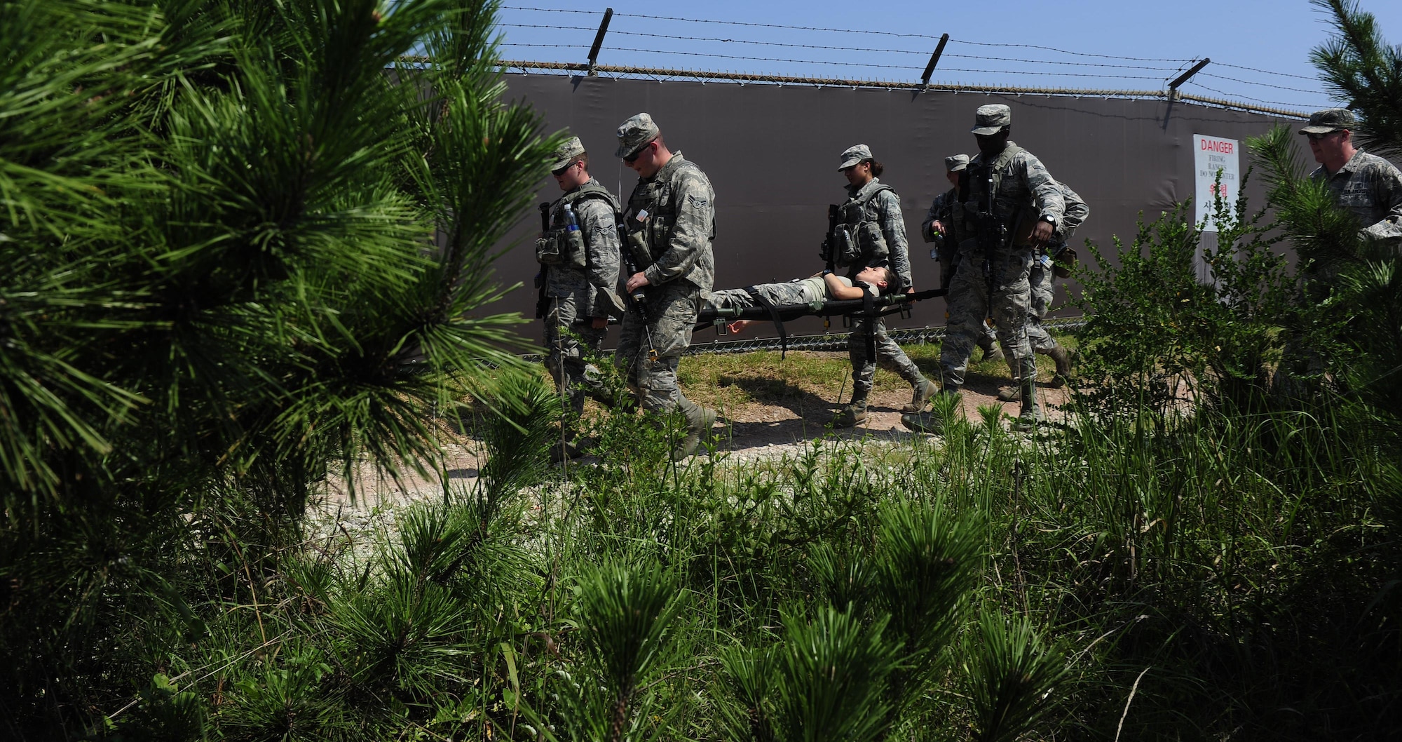 Airmen from the 8th Security Forces Squadron carry a litter during a tactical combat casualty care scenario during a three day combat readiness training exercise at Kunsan Air Base, Republic of Korea, August 3, 2015. As Kunsan’s first line of defense, security forces members must accurately and effectively perform their tactical capabilities to defend against threats. (U.S. Air Force photo by Staff Sgt. Nick Wilson/Released)