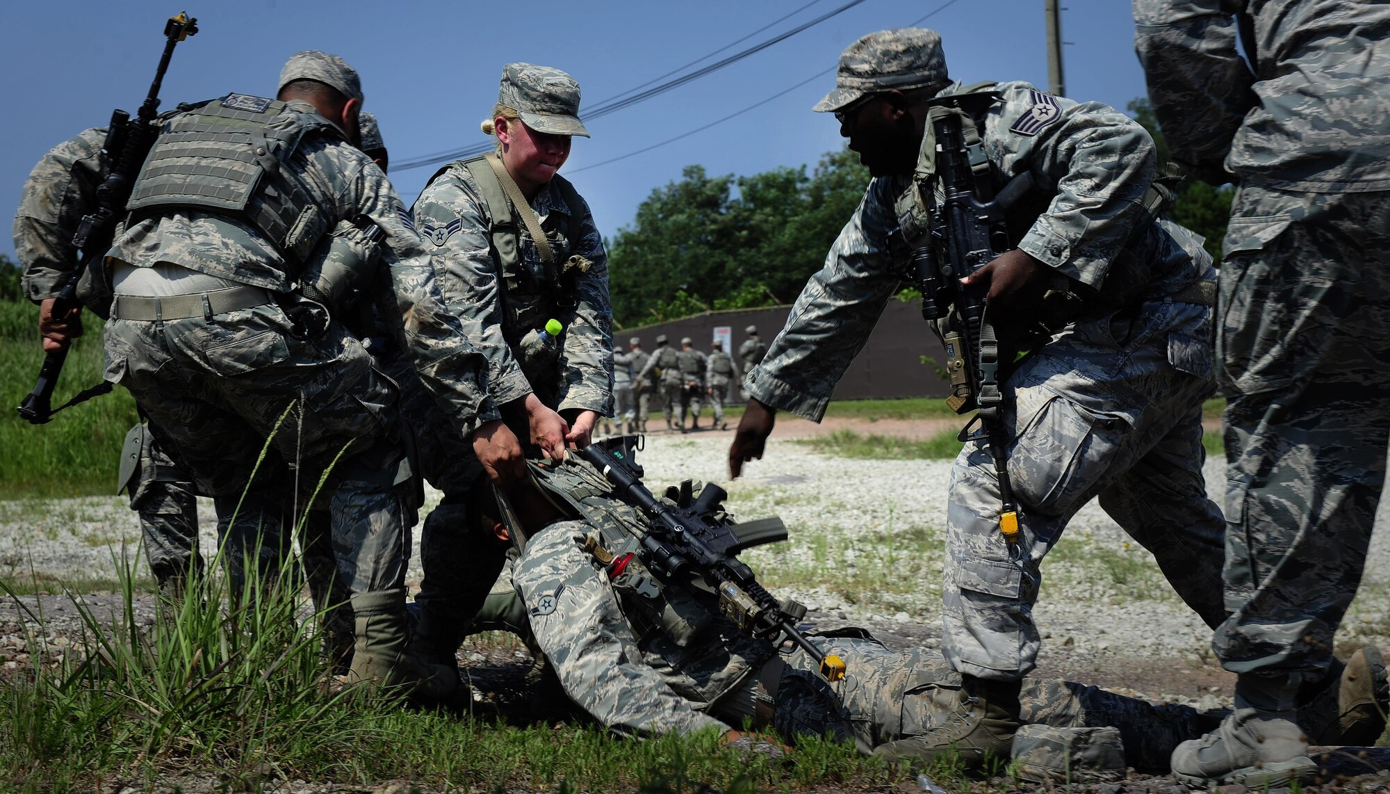 Airmen from the 8th Security Forces Squadron participate in a tactical combat casualty care scenario during a three day combat readiness training exercise at Kunsan Air Base, Republic of Korea, August 3, 2015. Integrating Airmen of all ranks with Republic of Korea air force members in quarterly CRTs strengthens teamwork to provide a higher level of safety and security of the Wolf Pack. (U.S. Air Force photo by Staff Sgt. Nick Wilson/Released)