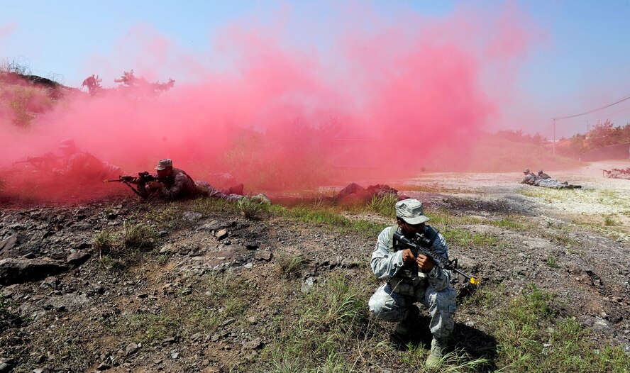 Airmen from the 8th Security Forces Squadron participate in a tactical combat casualty care scenario during a three day combat readiness training exercise at Kunsan Air Base, Republic of Korea, August 3, 2015. Integrating Airmen of all ranks with Republic of Korea air force members in quarterly CRTs strengthens teamwork to provide a higher level of safety and security of the Wolf Pack. (U.S. Air Force photo by Staff Sgt. Nick Wilson/Released)