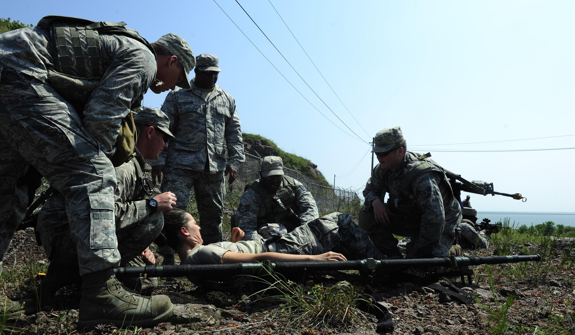 Airmen from the 8th Security Forces Squadron participate in a tactical combat casualty care scenario during a three day combat readiness training exercise at Kunsan Air Base, Republic of Korea, August 3, 2015. As Kunsan’s first line of defense, security forces members must accurately and effectively perform their tactical capabilities to defend against threats. (U.S. Air Force photo by Staff Sgt. Nick Wilson/Released)