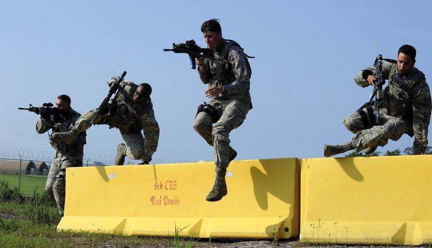 Airmen from the 8th Security Forces Squadron participate in a shoot, move and communicate drill during a three day combat readiness training exercise at Kunsan Air Base, Republic of Korea, Aug. 3, 2015. Airmen covered topics including mounted and dismounted operations, individual and small unit tactics, land navigation, shoot-move and communication, tactical communications, enemy prisoner of war procedures, self-aid buddy care and additional battlefield curriculums. (U.S. Air Force photo by Staff Sgt. Nick Wilson/Released)