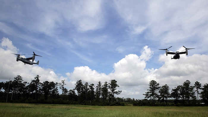 Two MV-22 Osprey aircraft with Marine Medium Tiltrotor Squadron 365, Marine Air Group 26, approach Landing Zone Bat during a confined landing area exercise at Marine Corps Base Camp Lejeune, North Carolina, Aug. 4, 2015 Marines with VMM-365 rehearsed different drop off and extraction scenarios at Landing Zone Bluebird and Landing Zone Bat at Camp Lejeune to maintain skills and standards within the squadron.