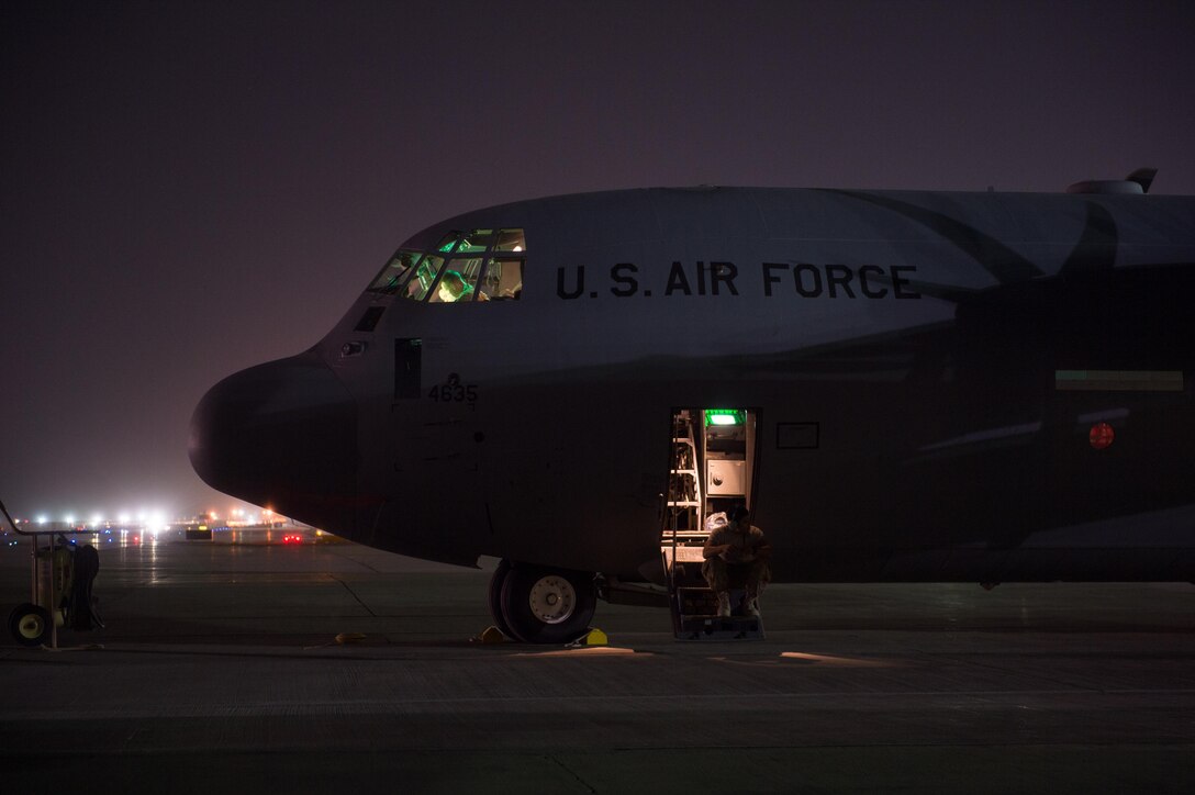 U.S. Air Force Senior Airman Julio Valencia, assigned to the 455th Expeditionary Aircraft Maintenance Squadron, waits for the engines to start during a preflight check on a C-130J Super Hercules aircraft on the flight line at Bagram Airfield, Afghanistan, Aug. 7, 2015.  The 455th EAMXS ensure Super Hercules on Bagram are prepared for flight and return them to a mission-ready state once they land. (U.S. Air Force photo by Tech. Sgt. Joseph Swafford/Released)