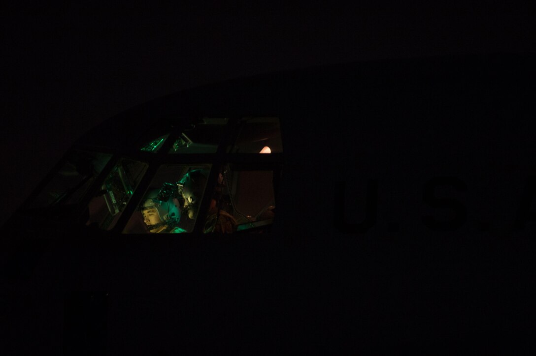 U.S. Airmen assigned to the 774th Expeditionary Airlift Squadron, go over preflight checks on a C-130J Super Hercules aircraft on the flight line at Bagram Airfield, Afghanistan, Aug. 7, 2015.  The aircraft is maintained by the 455th Expeditionary Aircraft Maintenance Squadron ensures Super Hercules on Bagram are prepared for flight and return them to a mission-ready state once they land. (U.S. Air Force photo by Tech. Sgt. Joseph Swafford/Released)