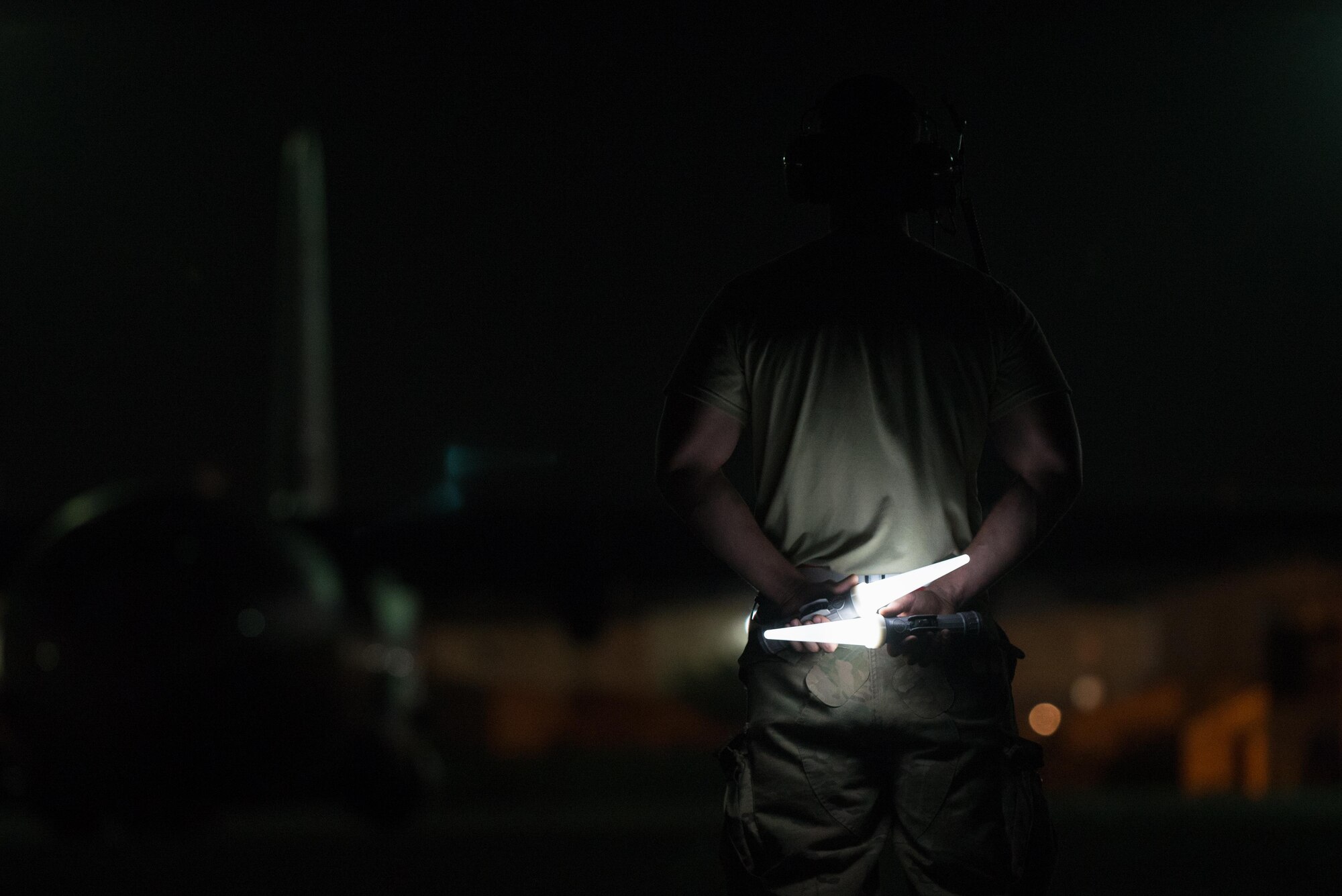 U.S. Air Force Senior Airman Chris Edgington, assigned to the 455th Expeditionary Aircraft Maintenance Squadron, waits to direct a C-130J Super Hercules aircraft on the flight line at Bagram Airfield, Afghanistan, Aug. 7, 2015.  The 455th EAMXS ensure Super Hercules on Bagram are prepared for flight and return them to a mission-ready state once they land. (U.S. Air Force photo by Tech. Sgt. Joseph Swafford/Released) 
