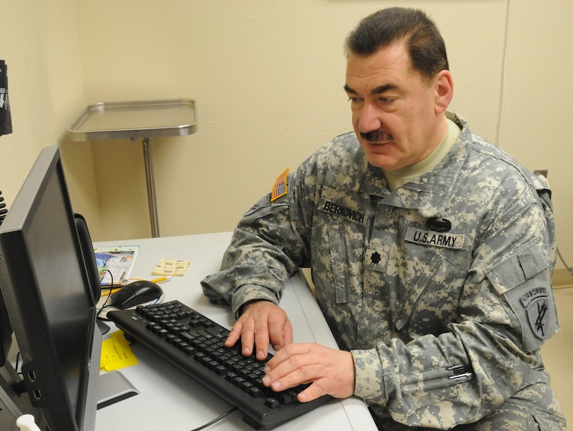 Army Reserve Lt. Col. Vladimir Berkovich, a medical doctor with chiropractic and acupuncture experience, and a member of the 7207th Medical Support Unit, Northeast Medical Area Readiness Support Group, Webster, N.Y., enters patient information on the computer while working at the Indian Health Service clinic in Lower Brule, S.D. Soldiers were sent to the reservation to provide necessary medical care to the Native American population in the area. (U.S. Army photo by Sgt. Beth Raney, 363rd Public Affairs Detachment/Released)