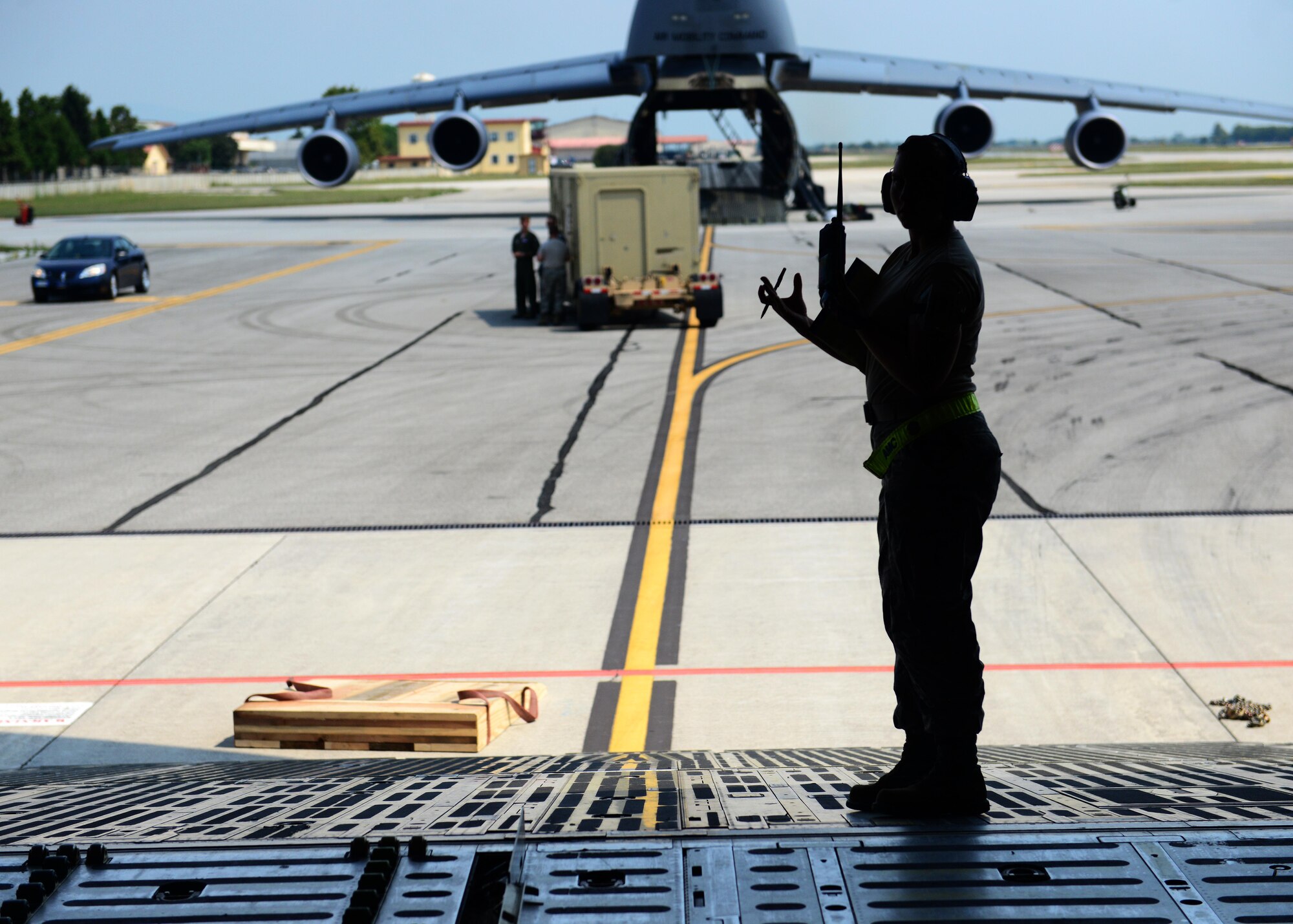 An Airman from the 724th Air Mobility Squadron oversees cargo loading procedures on a C-5 Super Galaxy delivering cargo in support of Operation Inherent Resolve Aug. 8, 2015, at Aviano Air Base, Italy. This deployment coincides with Turkey's decision to host U.S. aircraft to conduct counter-ISIL operations. (U.S. Air Force photo by Airman 1st Class Deana Heitzman)