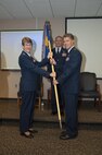 Lt. Col. Rick Chadwick, incoming 701st Airlift Squadron Commander, receives the squadron's guidon from Col. Caroline Evernham, 315th Operations Group Commander, during the formal change of command ceremony today at Joint Base Charleston, S.C. (U.S. Air Force photo by SSgt. Bobby Pilch)