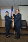 Col. Tom McNamara, outgoing 701st Airlift Squadron Commander, relinquishes the squadron's guidon to Col. Caroline Evernham, 315th Operations Group Commander, during the formal change of command ceremony today at Joint Base Charleston, S.C. (U.S. Air Force photo by SSgt. Bobby Pilch)