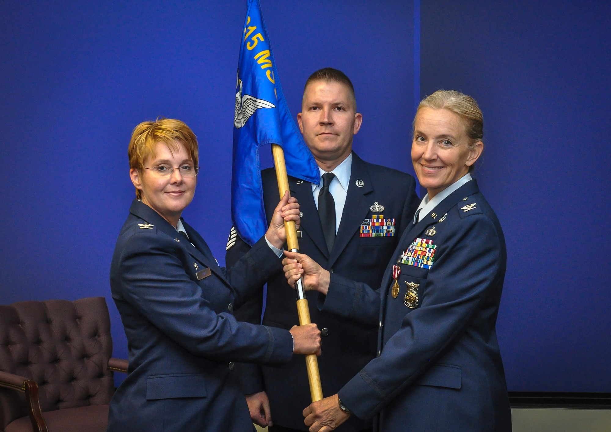 (Left) Col. Amber Kasbeer, outgoing 315th Civil Engineer Flight commander, passed the guide on to Col. Cherie Roff, 315th Mission Support Group commander, during a change of command ceremony Aug. 9, 2015, at Joint Base Charleston, S.C.  (U.S. Air Force photo by Senior Airman Tom Brading)
