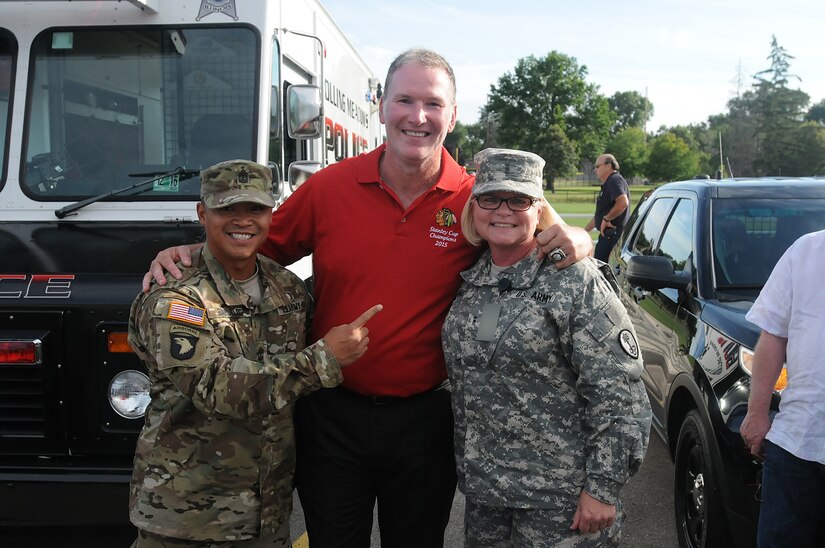 Army Reserve 1st. Sgt. Dominic Baruelo, left, and Chief Warrant Officer 2 Sabine Irby, right, both assigned to the 327th MP BN, 200th Military Police Command, pause for a photo with Chicago Blackhawks' national anthem singer, Jim Cornelison center, at the Rolling Meadows Police Department National Night Out community event, Aug. 4. Soldiers from the 85th Support Command also participated in the three-hour event here and simultaneously at the Village of Arlington Heights National Night Out event.
(U.S. Army photo by Spc. David Lietz/Released)