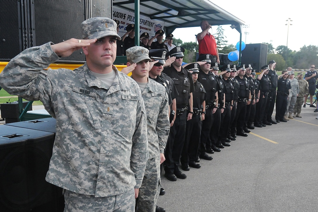 Second Lt. Michael Webb, left, physical security officer-in-charge for the 85th Support Command, renders a salute with police officers from the Rolling Meadows Police Department during the singing of the national anthem by Jim Cornelison, Chicago Blackhawks national anthem singer, at the Rolling Meadows Police National Night Out, Aug. 4.
Soldiers from the 85th Support Command participated in the three-hour event with soldiers from 327th Military Police Battalion, 200th Military Police Command there and simultaneously at the Village of Arlington Heights.
(U.S. Army photo by Spc. David Lietz/Released)