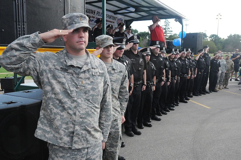 Second Lt. Michael Webb, left, physical security officer-in-charge for the 85th Support Command, renders a salute with police officers from the Rolling Meadows Police Department during the singing of the national anthem by Jim Cornelison, Chicago Blackhawks national anthem singer, at the Rolling Meadows Police National Night Out, Aug. 4.
Soldiers from the 85th Support Command participated in the three-hour event with soldiers from 327th Military Police Battalion, 200th Military Police Command there and simultaneously at the Village of Arlington Heights.
(U.S. Army photo by Spc. David Lietz/Released)