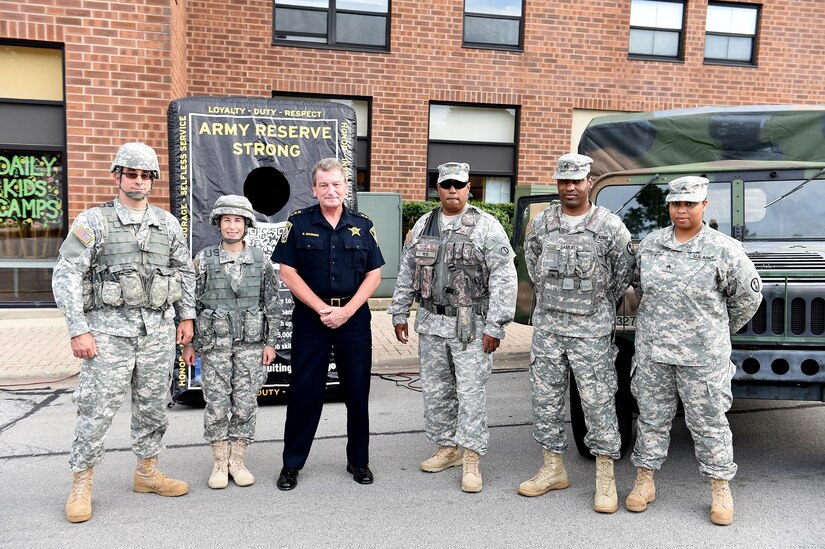 Army Reserve soldiers from the 85th Support Command and the 327th Military Police Battalion pause for a photo with Arlington Heights police chief, Gerald Mourning, during the Arlington Heights Police Department’s National Night Out (NNO) community event, Aug. 4.
The annual community event, which connects the local community with law enforcement and first responders, brought in an estimated 4000 in attendance. Soldiers also participated, simultaneously, in another NNO at the Village of Rolling Meadows.
(U.S. Army photo by Sgt. Aaron Berogan/Released)