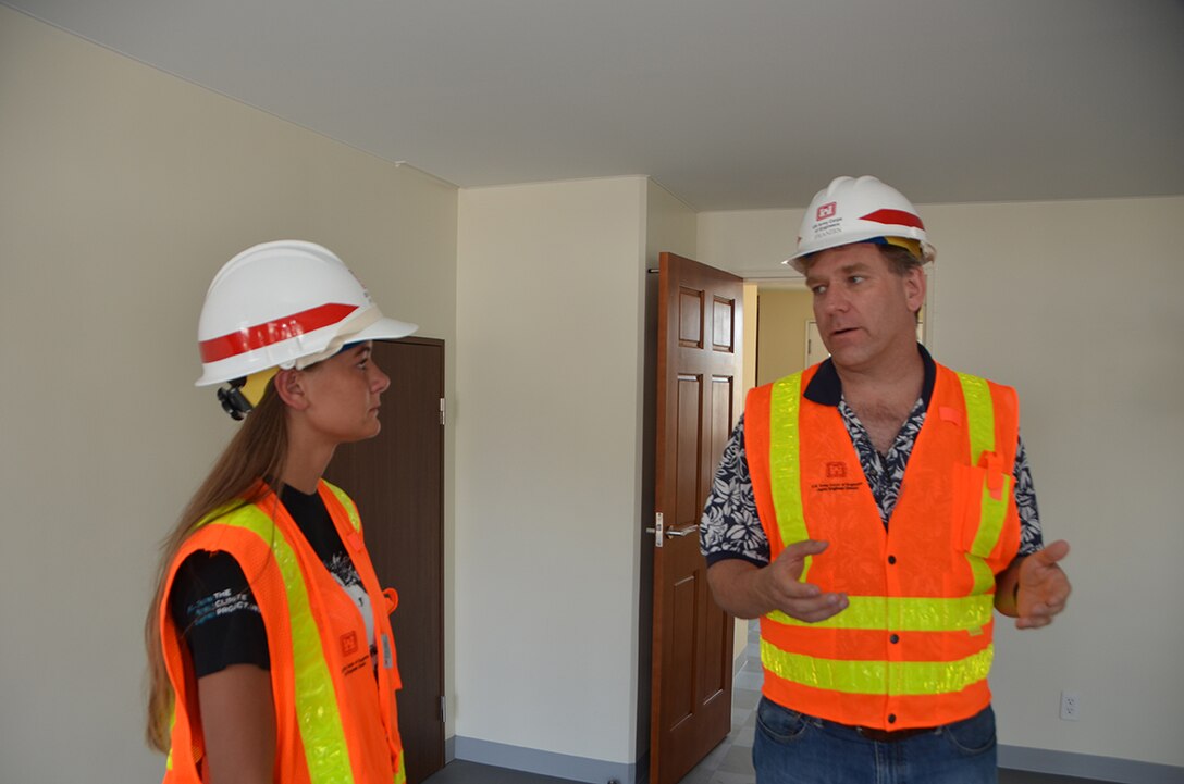 U.S. Army Corps of Engineers, Japan District summer hire student Amanda Davis listens to Kanagawa Resident Engineer Dave Franzen during a project site visit to Sagamihara Housing Area, near Camp Zama. 