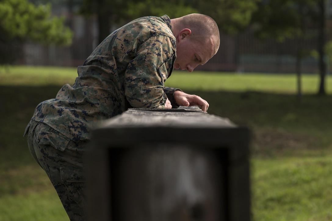 Cpl. Kenneth Hack, a field radio operator with Combat Logistics Company 36, climbs over the high wall during Exercise Dragon Fire 2015 at Combined Arms Training Center Camp Fuji, Japan, July 12. This physical training plays a vital role in developing a combat mindset, which is being prepared for the mental and physical stresses adhered to a combat environment. This annual exercise is used to enhance the service members’ tactical skill sets taught to them in their initial training as well as develop a combat mindset.