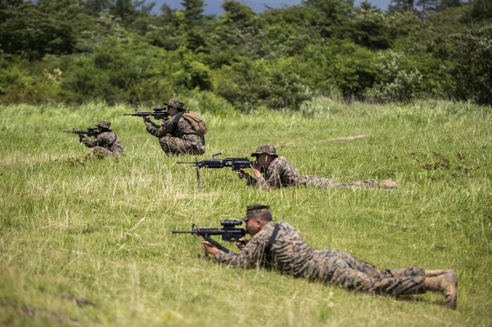 Marines with Combat Logistics Company 36 practice their fire and maneuver tactics during Exercise Dragon Fire 2015 at Combined Arms Training Center Camp Fuji, Japan, July 21. Service members participated in live-fire ranges, land navigation, and conducted convoy and recovery operations during the annual exercise to enhance their combat readiness.