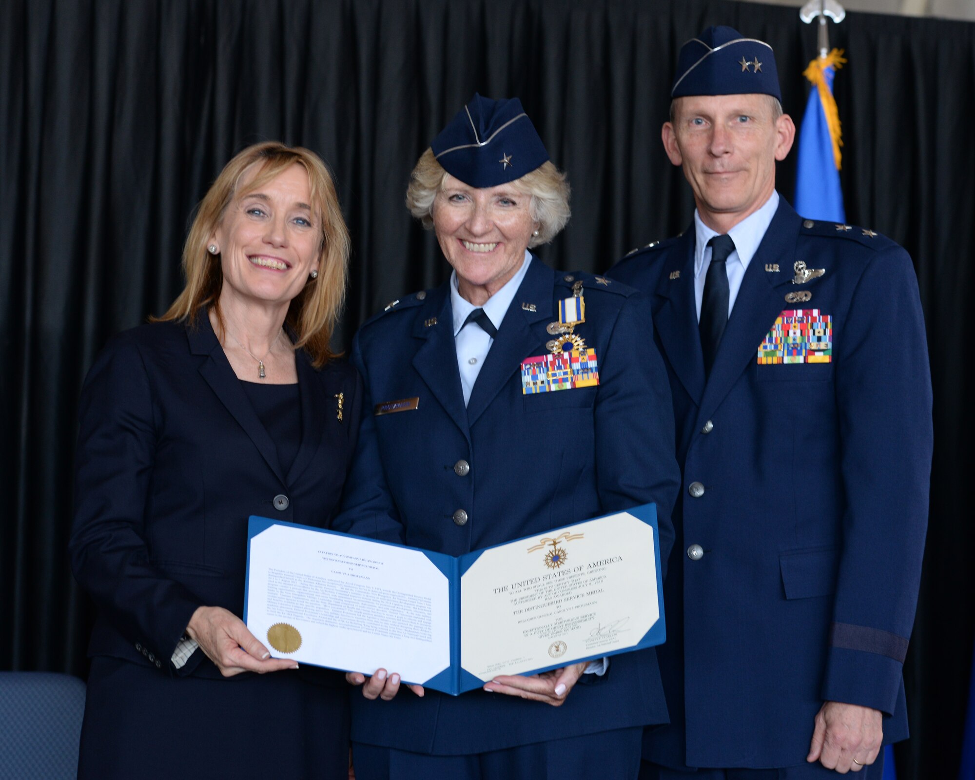 New Hampshire Gov. Maggie Hassan, Brig. Gen. (Ret.) Carolyn J. Protzmann, and the Adjutant General, New Hampshire National Guard Maj. Gen. William N. Reddel III pose for a  photo during Protzmann's retirement  ceremony at Pease Air National Base, N.H., on Aug. 9, 2015. Protzmann retired from the NHANG after 36 years of military service. Brig. Gen. Paul Hutchinson assumed command of the NHANG from Protzmann.  (U.S. Air National Guard photo by Staff Sgt. Curtis J. Lenz)