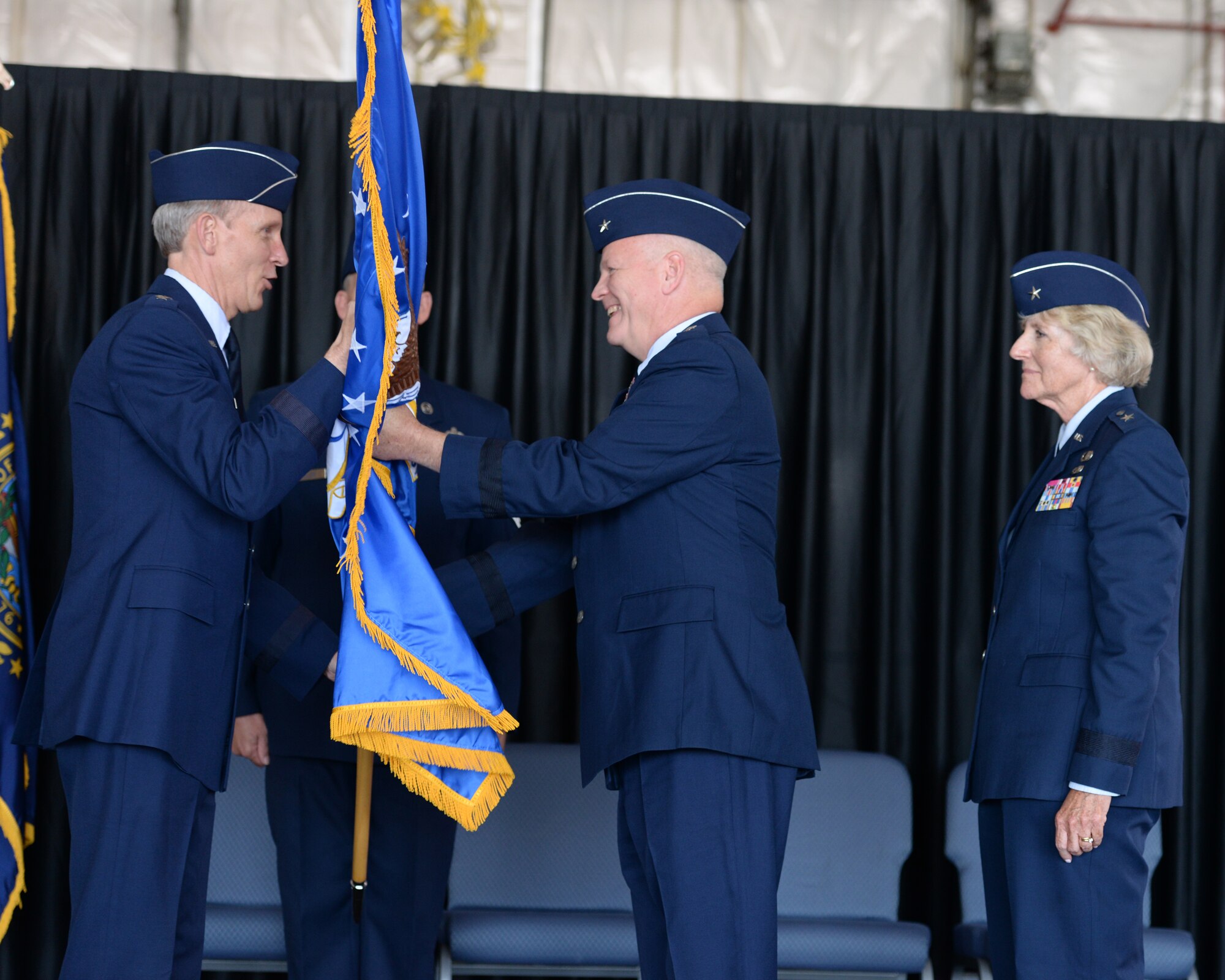 Brig. Gen. Paul Hutchinson receives a guidon from the Adjutant General, New Hampshire National Guard Maj. Gen. William N. Reddel III during a ceremony at Pease Air National Guard Base, N.H., on Aug. 9, 2015. Hutchinson assumed command of the NHANG from Brig. Gen. Carolyn J. Protzmann. (U.S. Air National Guard photo by Staff Sgt. Curtis J. Lenz)